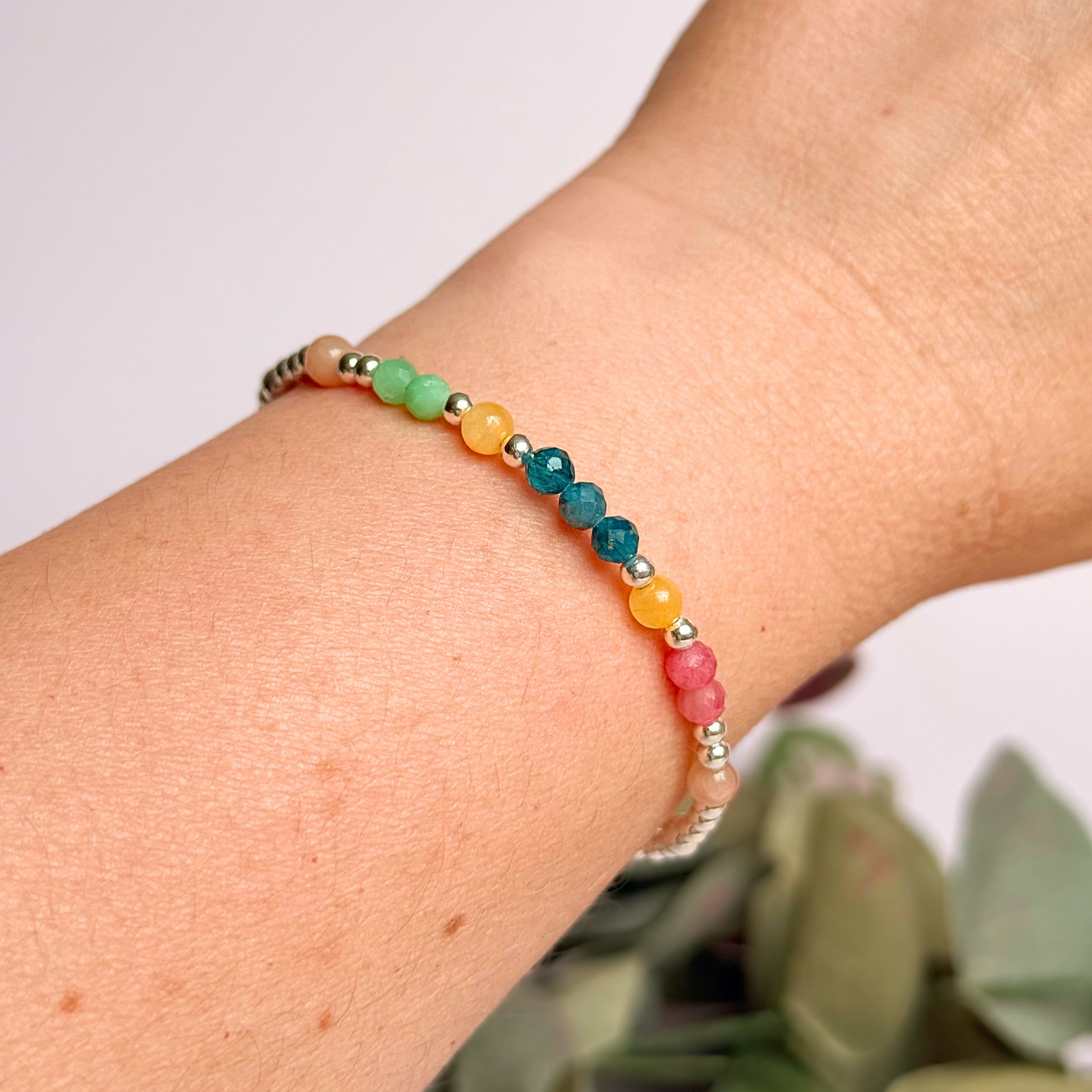 'Key West' sterling silver dainty beaded bracelet with apatite, rhodochrosite, yellow calcite, chrysoprase and peach moonstone. Made with round 3mm sterling silver beads and 4mm smooth and faceted round crystal gemstone beads. Pictured being worn
