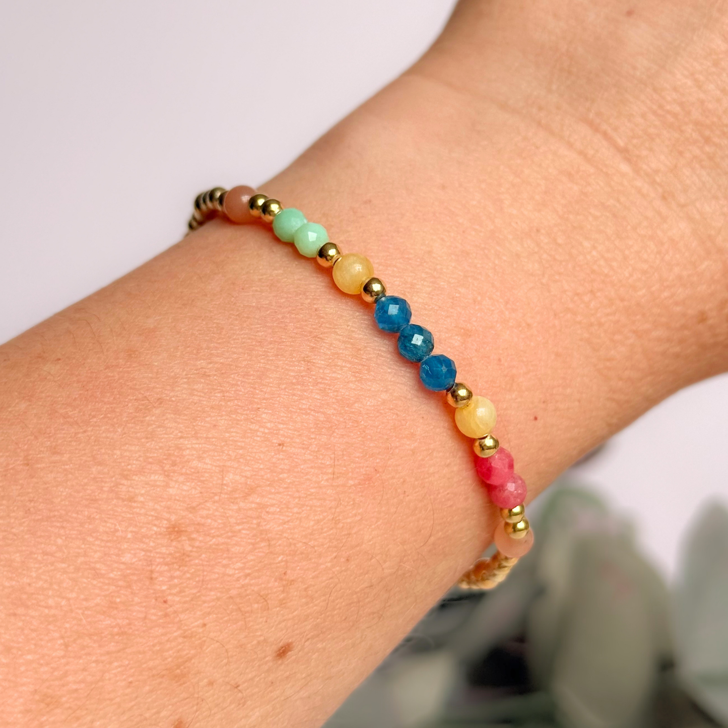 'Key West' gold vermeil dainty beaded bracelet with apatite, rhodochrosite, yellow calcite, chrysoprase and peach moonstone. Made with round 3mm gold vermeil beads and 4mm smooth and faceted round crystal gemstone beads. Pictured being worn.