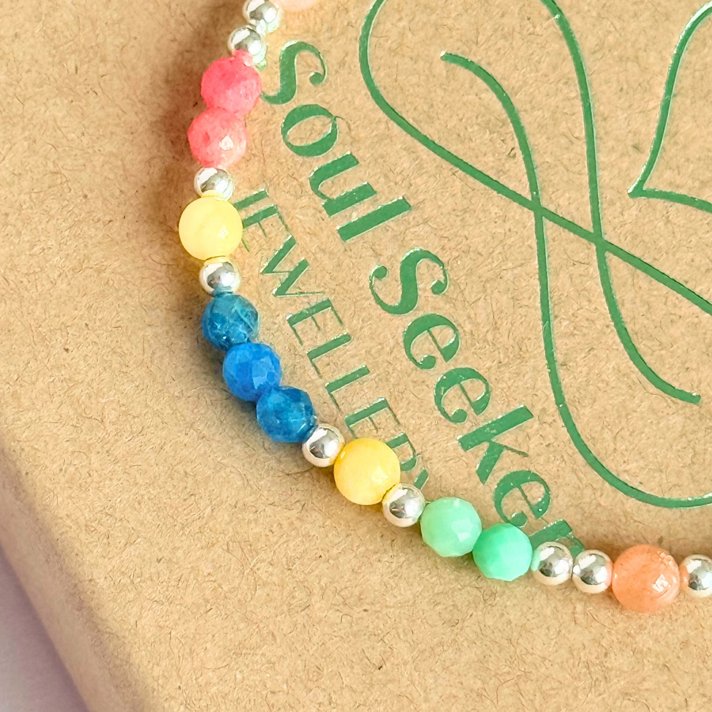 'Key West' sterling silver dainty beaded bracelet with apatite, rhodochrosite, yellow calcite, chrysoprase and peach moonstone. Made with round 3mm sterling silver beads and 4mm smooth and faceted round crystal gemstone beads. Pictured close up, on the gift box