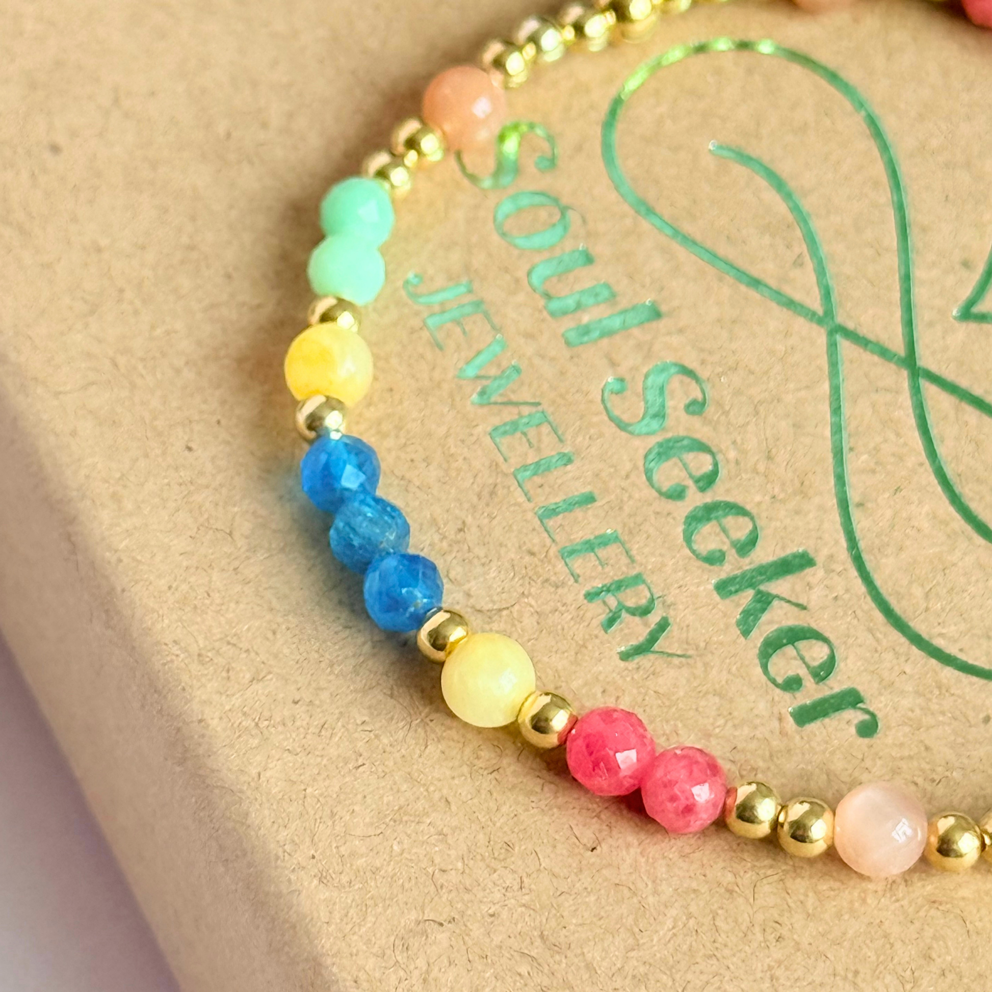 'Key West' gold vermeil dainty beaded bracelet with apatite, rhodochrosite, yellow calcite, chrysoprase and peach moonstone. Made with round 3mm gold vermeil beads and 4mm smooth and faceted round crystal gemstone beads. Pictured close up, on the box