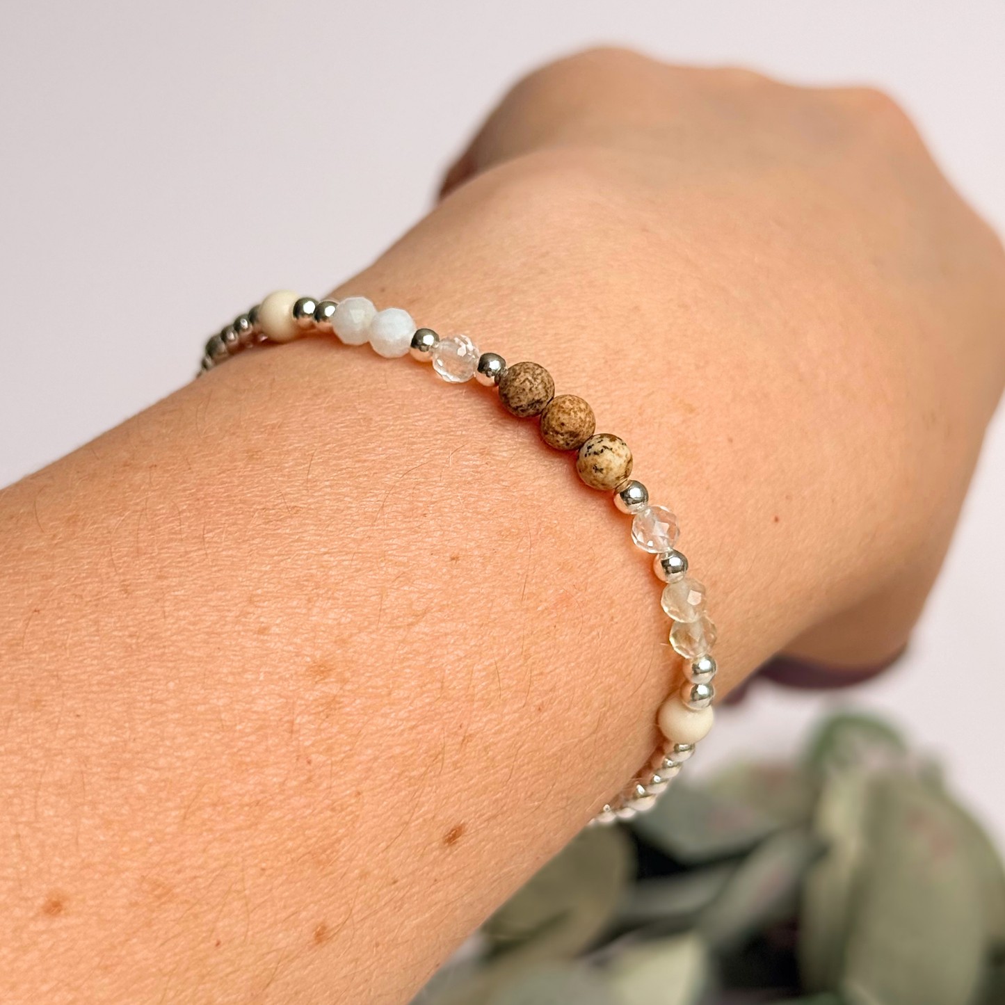 'Ibiza Bohemia' sterling silver dainty beaded bracelet with picture jasper, river stone jasper, citrine, clear quartz and moonstone. Made with round 3mm sterling silver beads and 4mm smooth and faceted round crystal gemstone beads. Pictured being worn, at an angle.