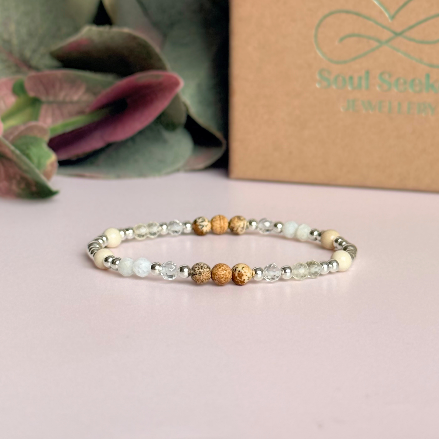 'Ibiza Bohemia' sterling silver dainty beaded bracelet with picture jasper, river stone jasper, citrine, clear quartz and moonstone. Made with round 3mm sterling silver beads and 4mm smooth and faceted round crystal gemstone beads. Pictured in front of the gift box
