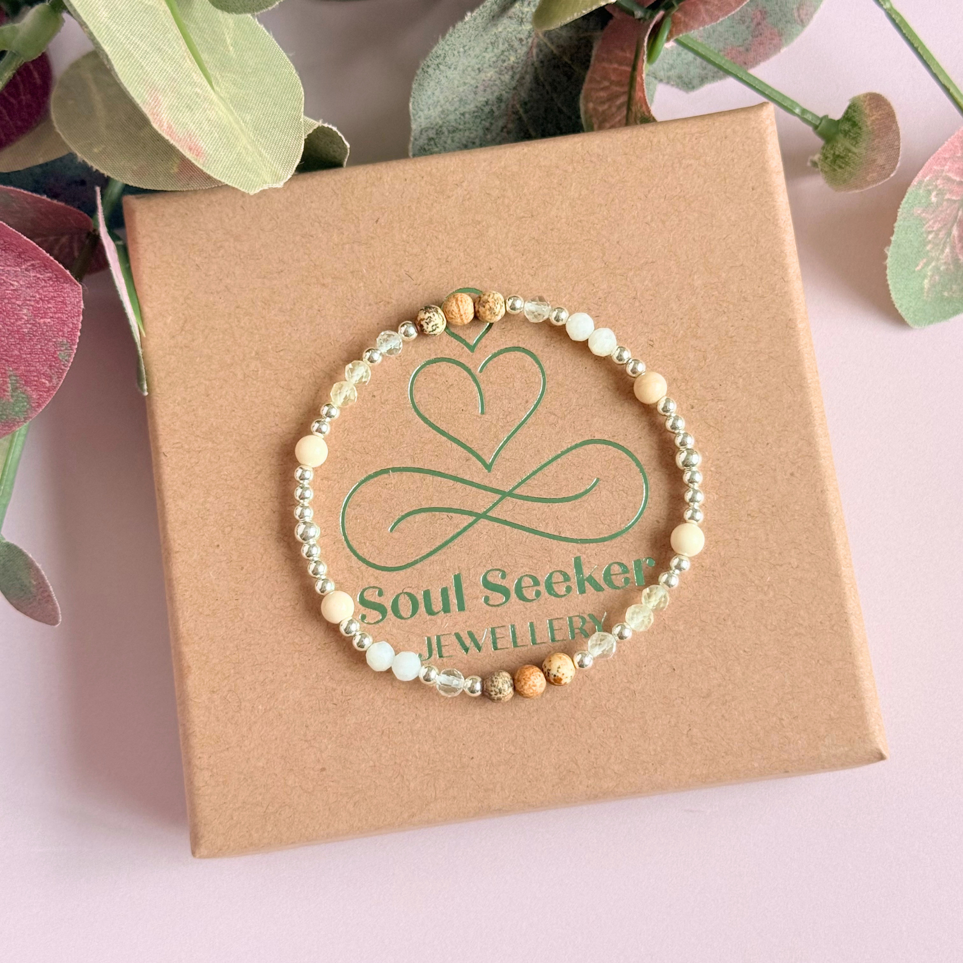 'Ibiza Bohemia' sterling silver dainty beaded bracelet with picture jasper, river stone jasper, citrine, clear quartz and moonstone. Made with round 3mm sterling silver beads and 4mm smooth and faceted round crystal gemstone beads. Pictured on the gift box, from above