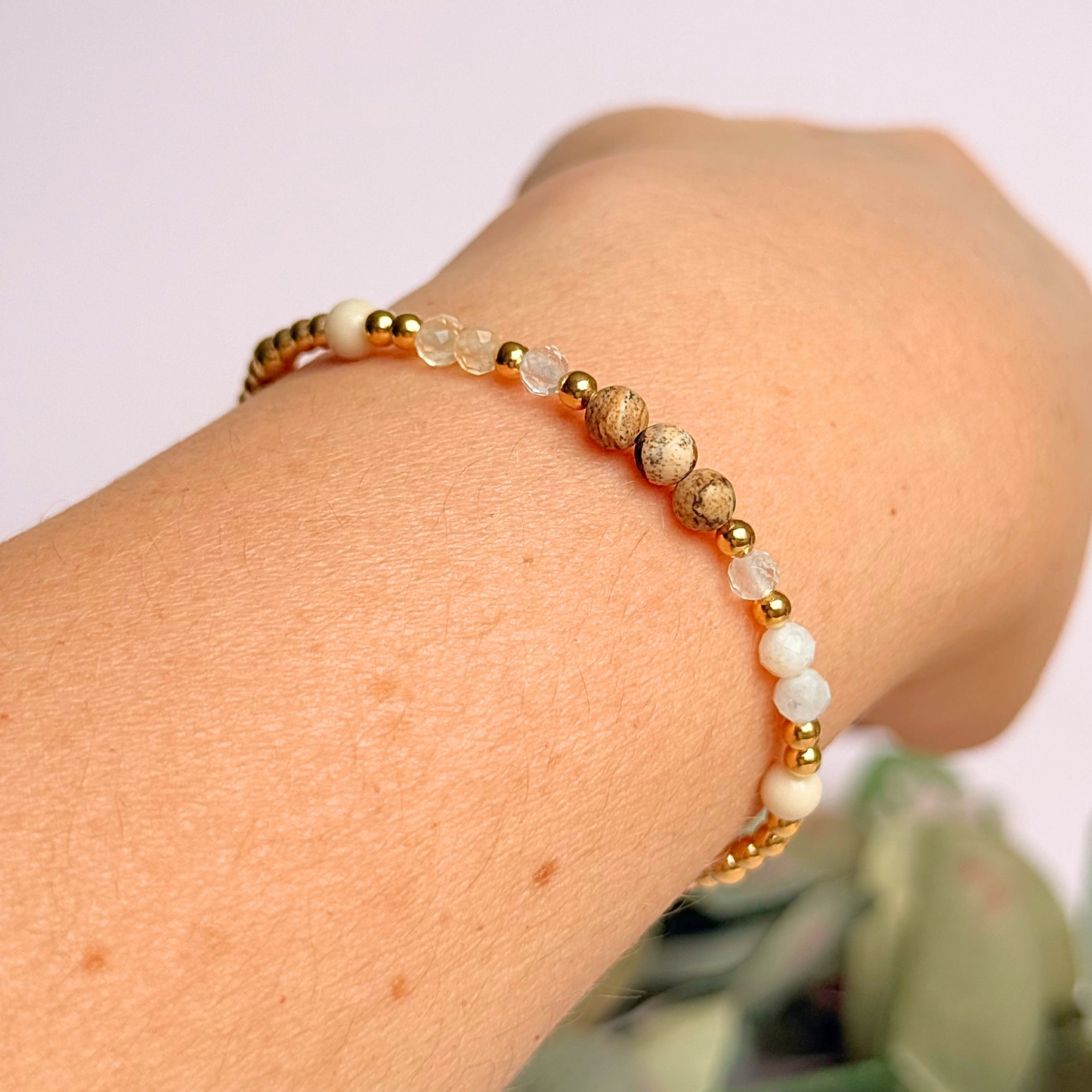 'Ibiza Bohemia' gold vermeil dainty beaded bracelet with picture jasper, river stone jasper, citrine, clear quartz and moonstone. Made with round 3mm gold vermeil beads and 4mm smooth and faceted round crystal gemstone beads. Pictured being worn, at an angle.