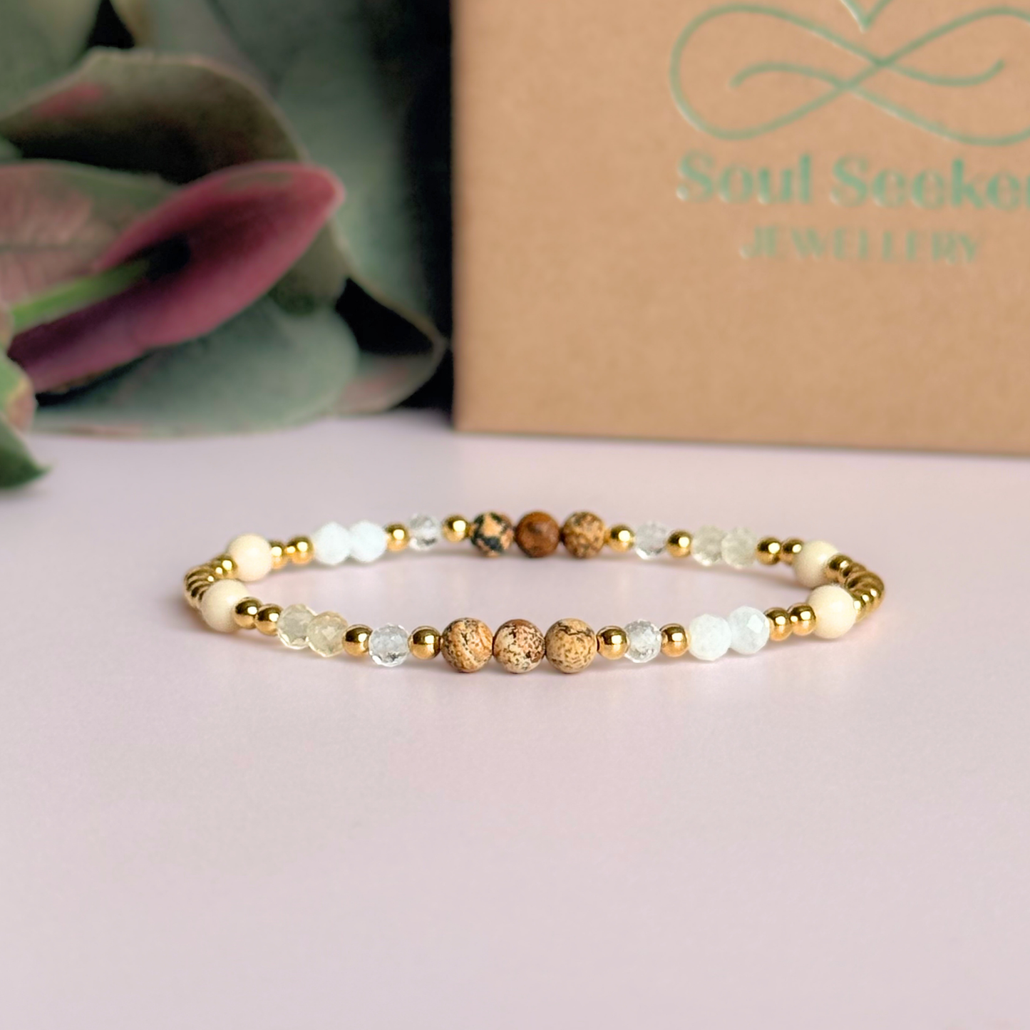 'Ibiza Bohemia' gold vermeil dainty beaded bracelet with picture jasper, river stone jasper, citrine, clear quartz and moonstone. Made with round 3mm gold vermeil beads and 4mm smooth and faceted round crystal gemstone beads. Pictured in front of the gift box.