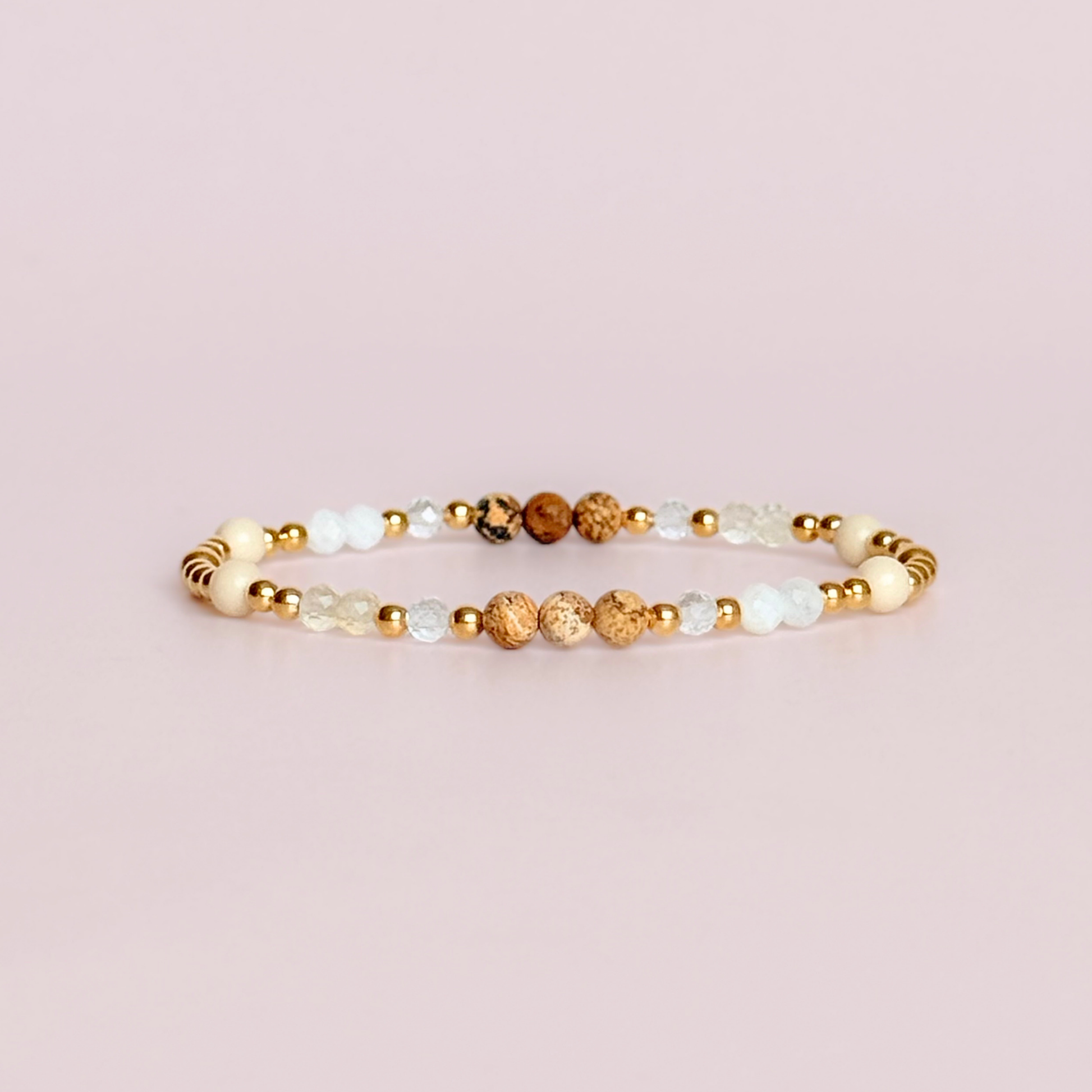 'Ibiza Bohemia' gold vermeil dainty beaded bracelet with picture jasper, river stone jasper, citrine, clear quartz and moonstone. Made with round 3mm gold vermeil beads and 4mm smooth and faceted round crystal gemstone beads. Pictured against a pink background.