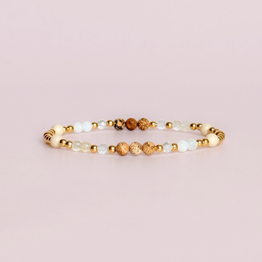 'Ibiza Bohemia' gold vermeil dainty beaded bracelet with picture jasper, river stone jasper, citrine, clear quartz and moonstone. Made with round 3mm gold vermeil beads and 4mm smooth and faceted round crystal gemstone beads. Pictured against a pink background.