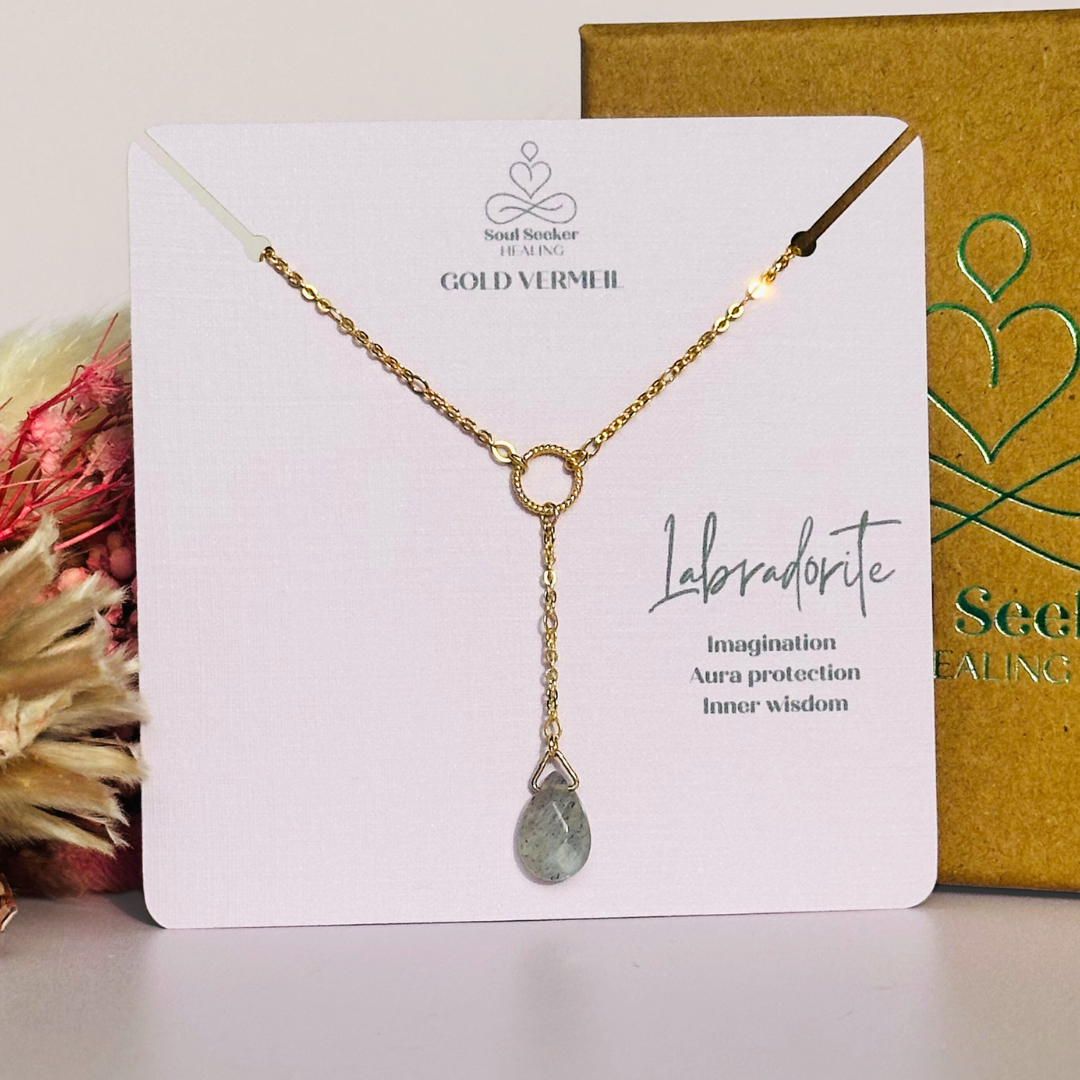 Labradorite necklace featuring a faceted labradorite teardrop bead on a delicate gold vermeil figaro chain with a twisted gold vermeil ring focal point. The necklace fastens with a subtle yet secure gold vermeil bolt clasp. The teardrop bead measures 12mm x 8mm.