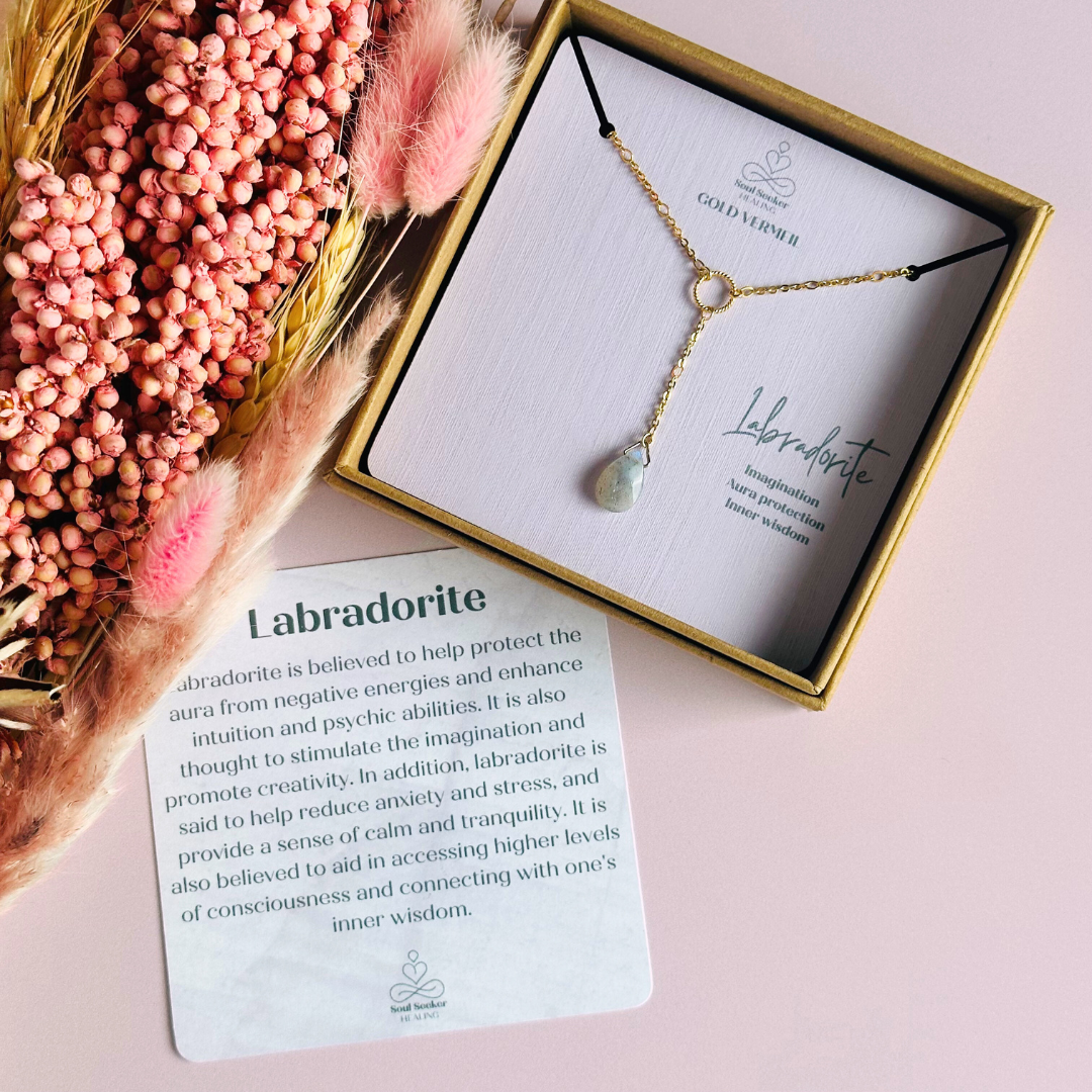 Labradorite necklace featuring a faceted labradorite teardrop bead on a delicate gold vermeil figaro chain with a twisted gold vermeil ring focal point. The necklace fastens with a subtle yet secure gold vermeil bolt clasp. The teardrop bead measures 12mm x 8mm.