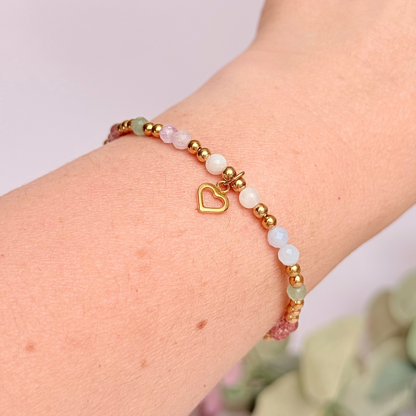 'Soft girl summer' gold vermeil dainty beaded bracelet with Kunzite, moonstone, green aventurine, blue lace agate and strawberry quartz . With a beautiful open heart charm.Made with round 3mm gold vermeil beads and 4mm smooth and faceted round crystal gemstone beads. Pictured being worn