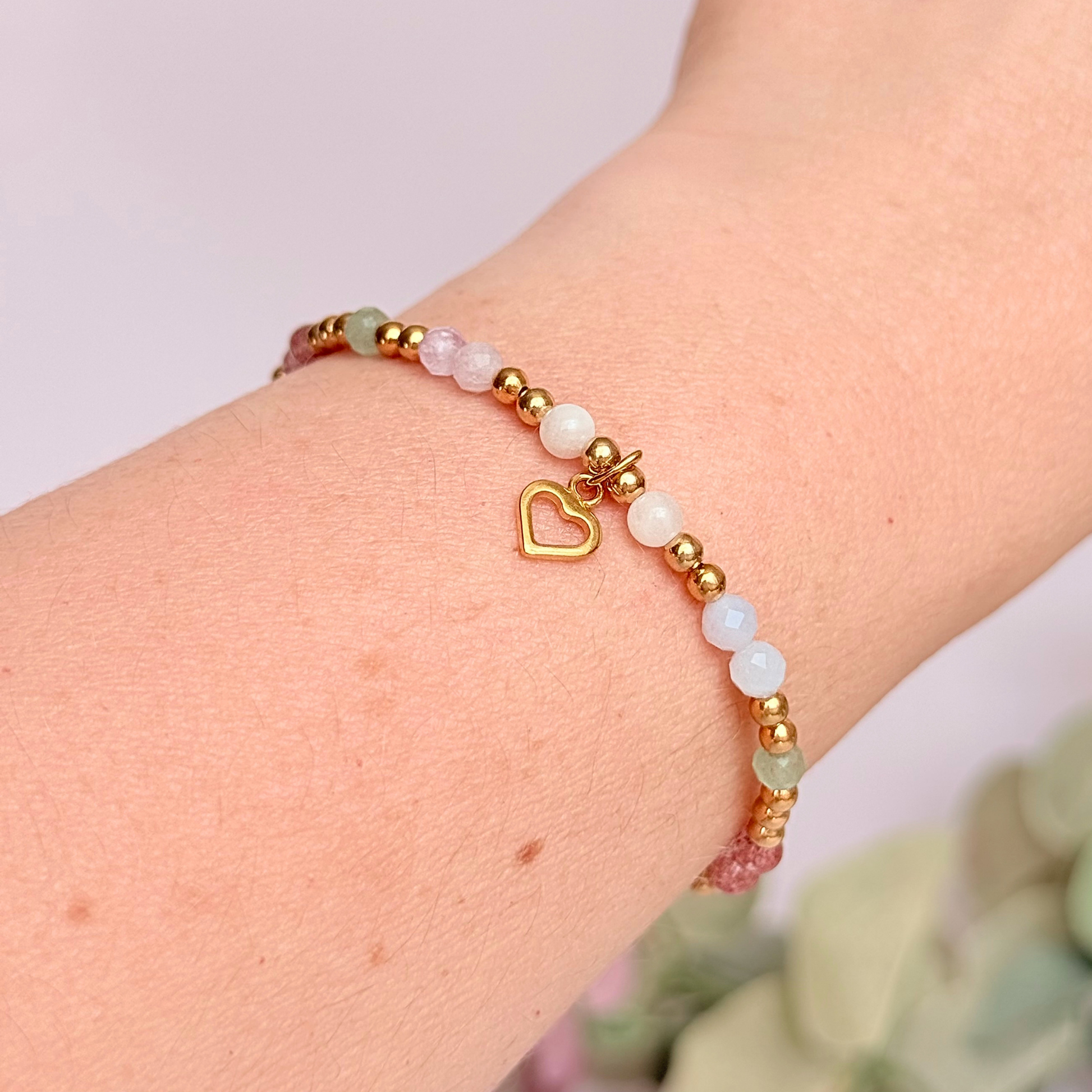 'Soft girl summer' gold vermeil dainty beaded bracelet with Kunzite, moonstone, green aventurine, blue lace agate and strawberry quartz . With a beautiful open heart charm.Made with round 3mm gold vermeil beads and 4mm smooth and faceted round crystal gemstone beads. Pictured being worn