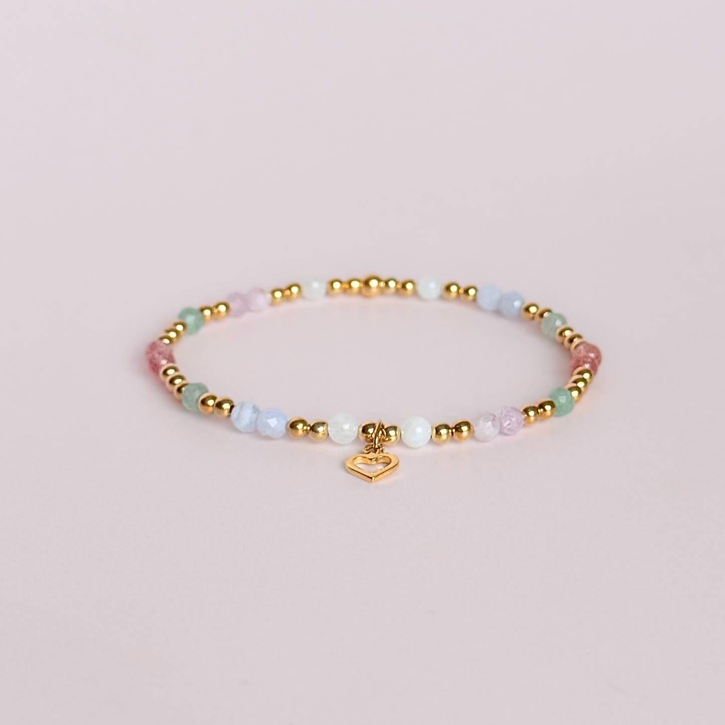 'Soft girl summer' gold vermeil dainty beaded bracelet with Kunzite, moonstone, green aventurine, blue lace agate and strawberry quartz . With a beautiful open heart charm.Made with round 3mm gold vermeil beads and 4mm smooth and faceted round crystal gemstone beads. Pictured on a pink background