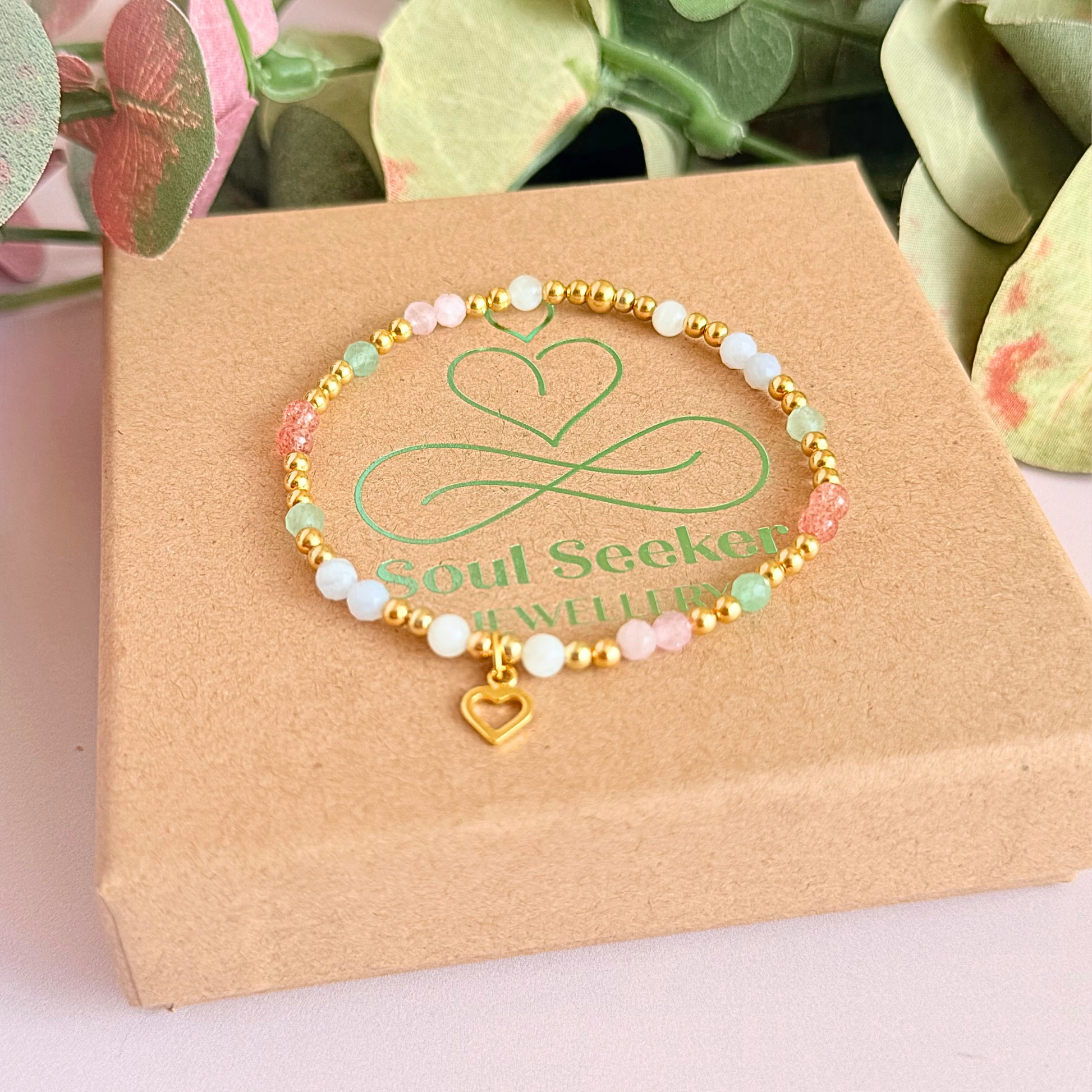 'Soft girl summer' gold vermeil dainty beaded bracelet with Kunzite, moonstone, green aventurine, blue lace agate and strawberry quartz . With a beautiful open heart charm.Made with round 3mm gold vermeil beads and 4mm smooth and faceted round crystal gemstone beads. Pictured on the box