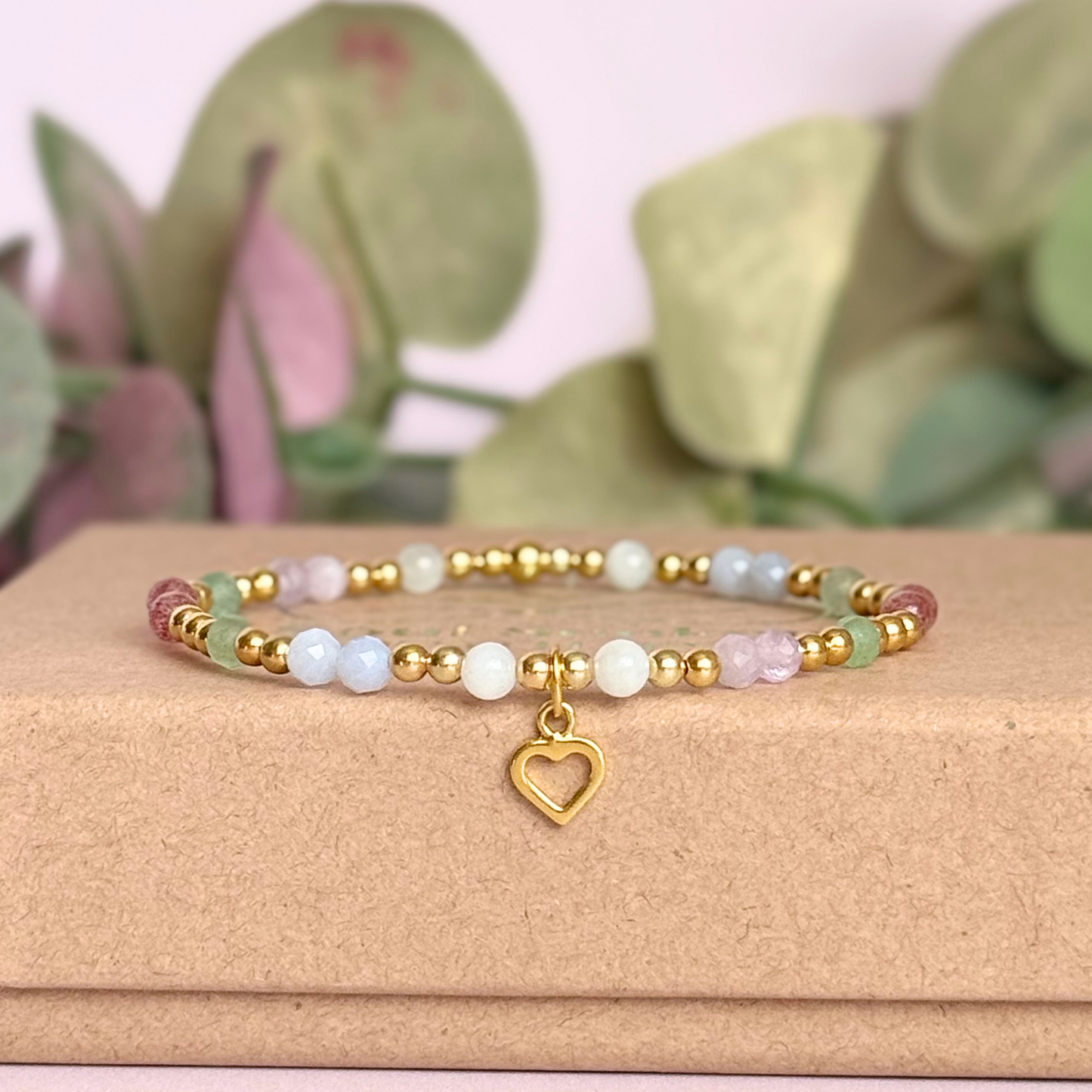 'Soft girl summer' gold vermeil dainty beaded bracelet with Kunzite, moonstone, green aventurine, blue lace agate and strawberry quartz . With a beautiful open heart charm.Made with round 3mm gold vermeil beads and 4mm smooth and faceted round crystal gemstone beads. Pictured on the box