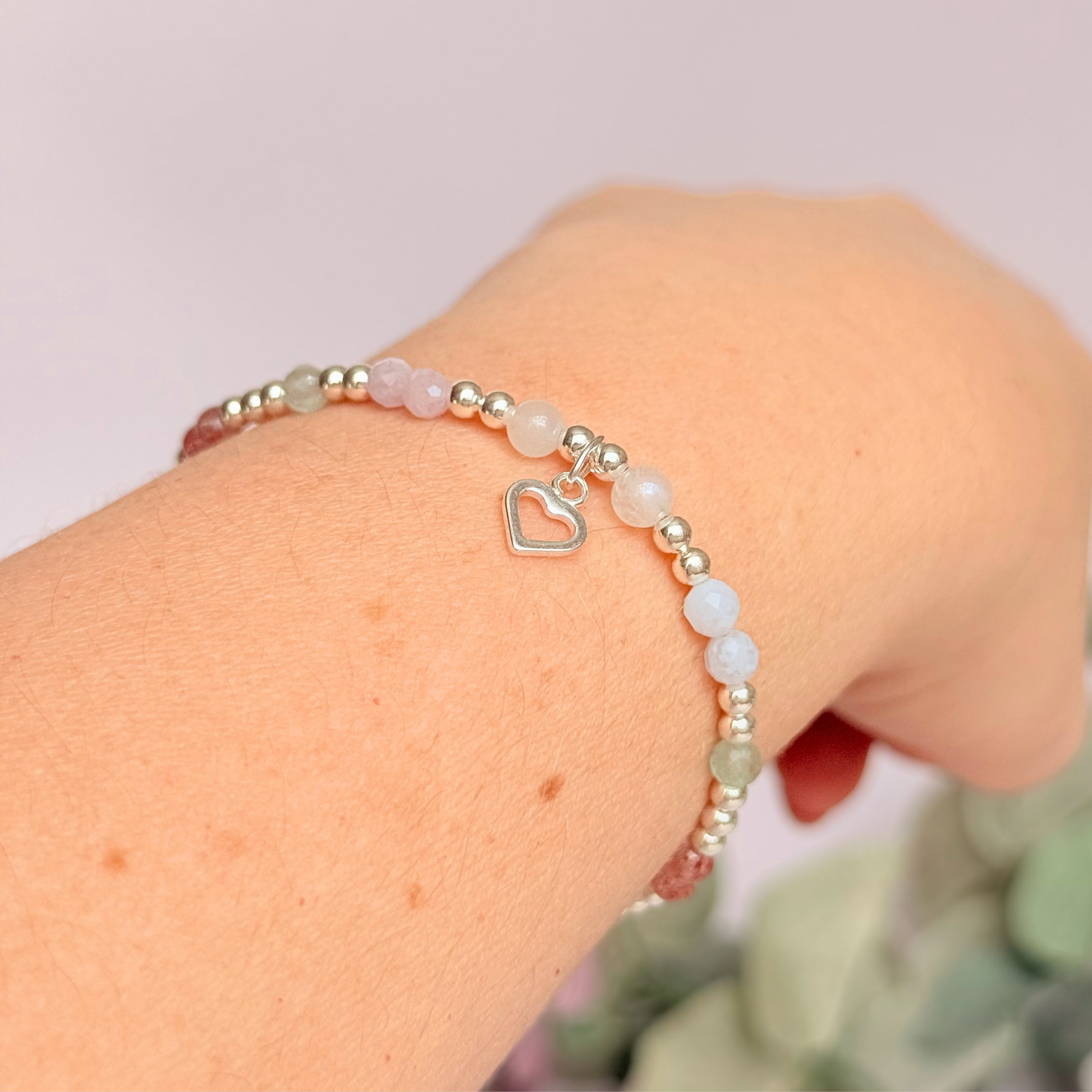'Soft girl summer' sterling silver dainty beaded bracelet with Kunzite, moonstone, green aventurine, blue lace agate and strawberry quartz . With a beautiful open heart charm.Made with round 3mm sterling silver beads and 4mm smooth and faceted round crystal gemstone beads. Pictured being worn, on an angle