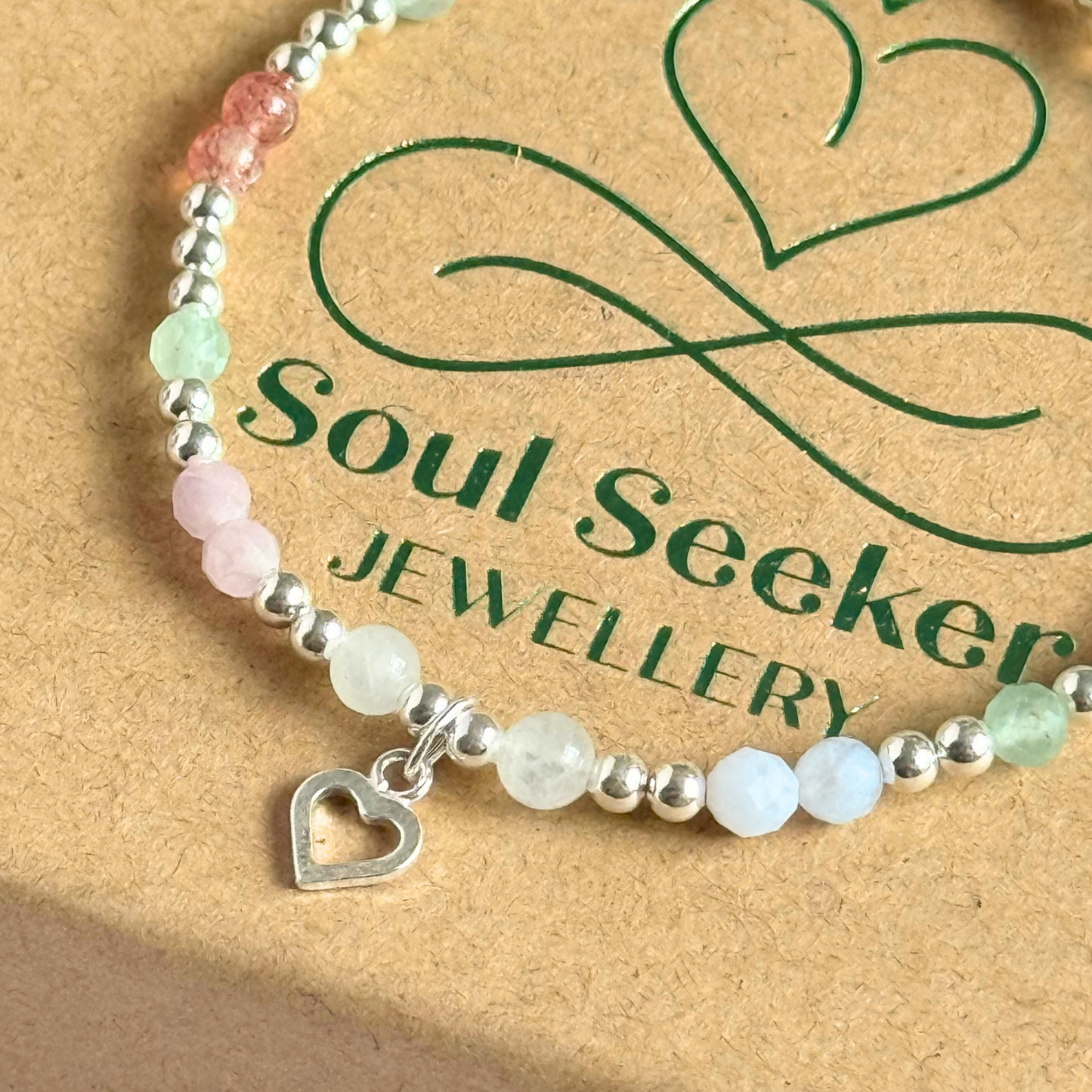 'Soft girl summer' sterling silver dainty beaded bracelet with Kunzite, moonstone, green aventurine, blue lace agate and strawberry quartz . With a beautiful open heart charm.Made with round 3mm sterling silver beads and 4mm smooth and faceted round crystal gemstone beads. Pictured close up, on the box