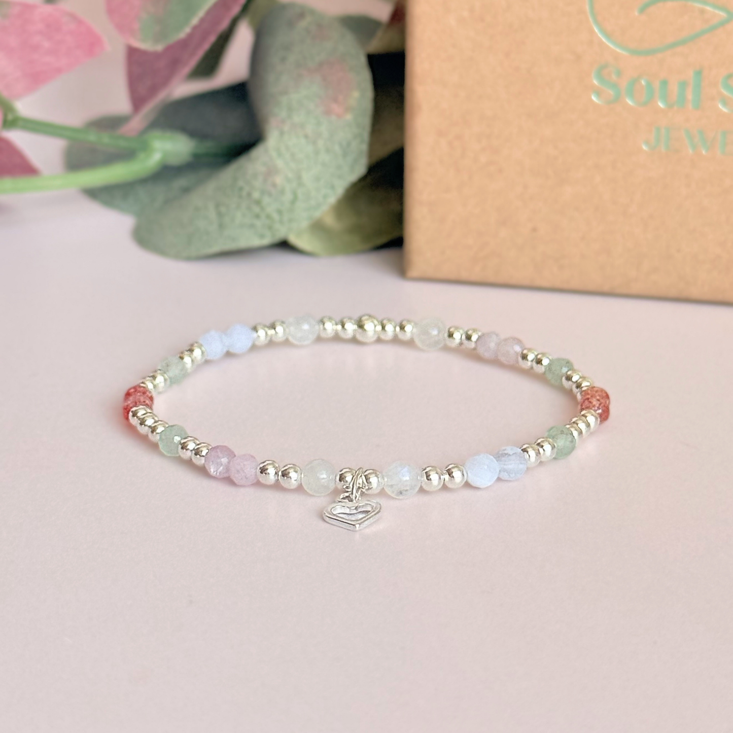 'Soft girl summer' sterling silver dainty beaded bracelet with Kunzite, moonstone, green aventurine, blue lace agate and strawberry quartz . With a beautiful open heart charm.Made with round 3mm sterling silver beads and 4mm smooth and faceted round crystal gemstone beads. Pictured in front of the gift box