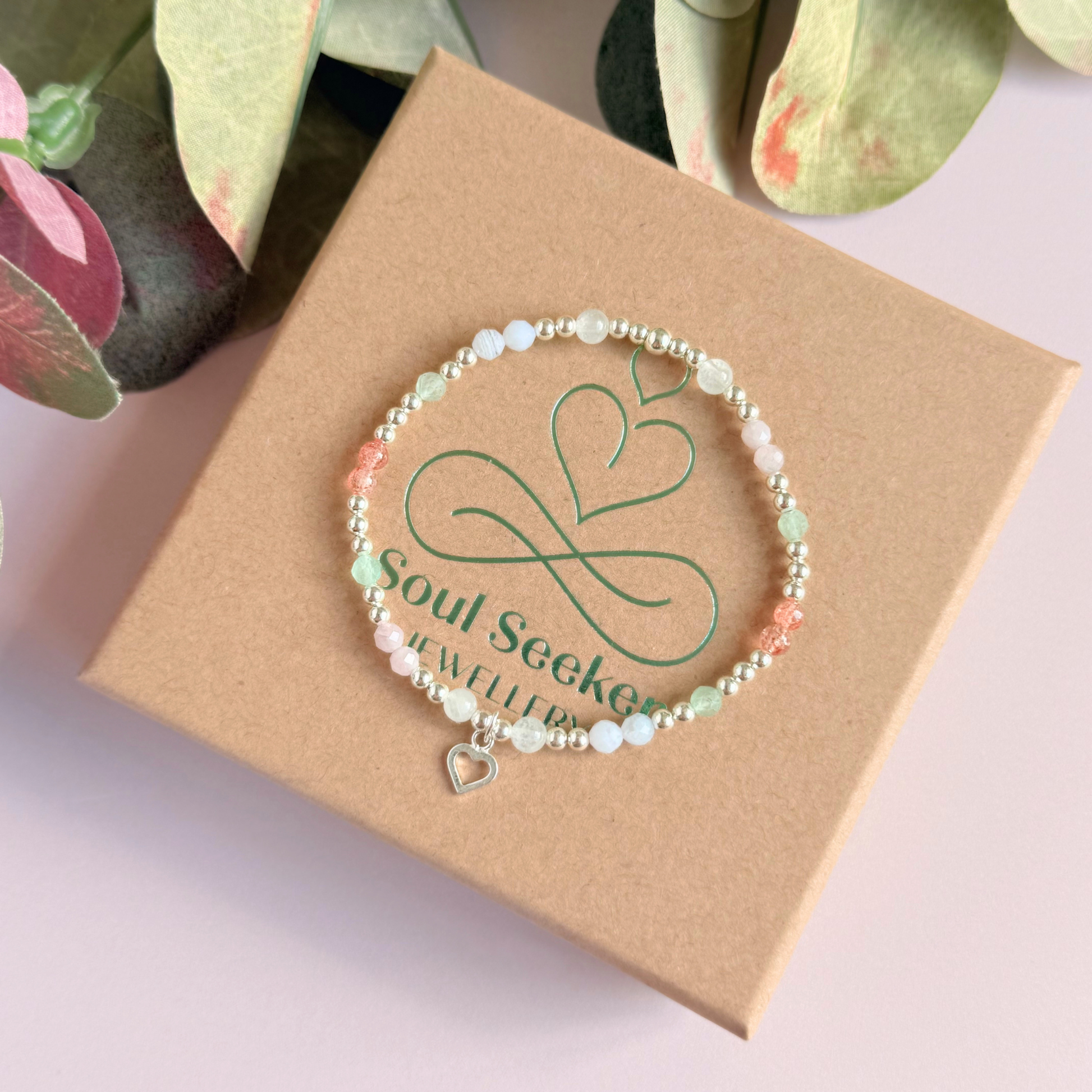 'Soft girl summer' sterling silver dainty beaded bracelet with Kunzite, moonstone, green aventurine, blue lace agate and strawberry quartz . With a beautiful open heart charm.Made with round 3mm sterling silver beads and 4mm smooth and faceted round crystal gemstone beads. Pictured on the box