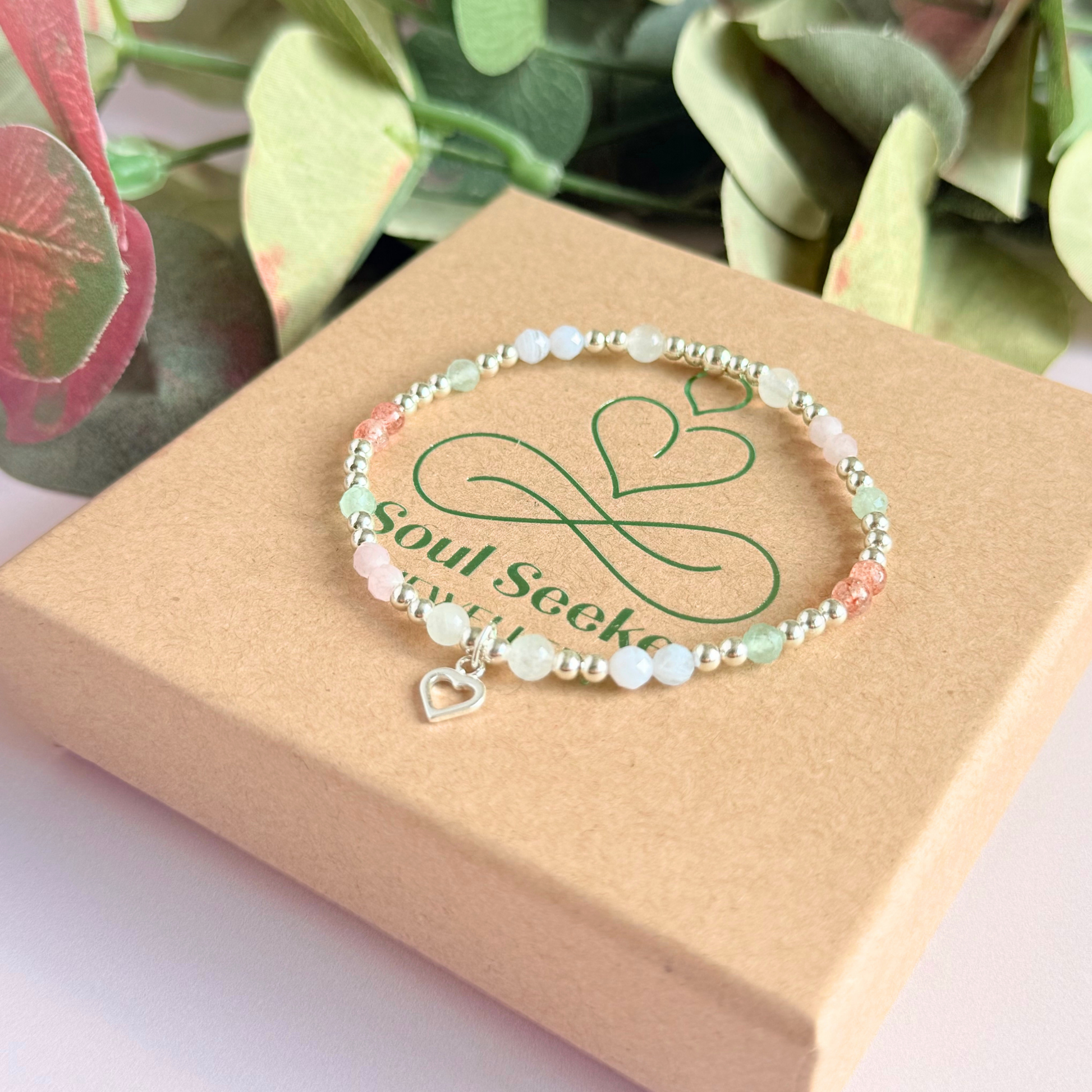 'Soft girl summer' sterling silver dainty beaded bracelet with Kunzite, moonstone, green aventurine, blue lace agate and strawberry quartz . With a beautiful open heart charm.Made with round 3mm sterling silver beads and 4mm smooth and faceted round crystal gemstone beads. Pictured on top of the gift box