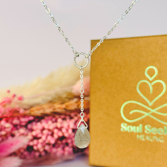 Labradorite necklace featuring a faceted labradorite teardrop bead on a delicate sterling silver chain with a twisted sterling silver ring focal point. The necklace fastens with a subtle yet secure sterling silver bolt clasp. The teardrop bead measures 12mm x 8mm.