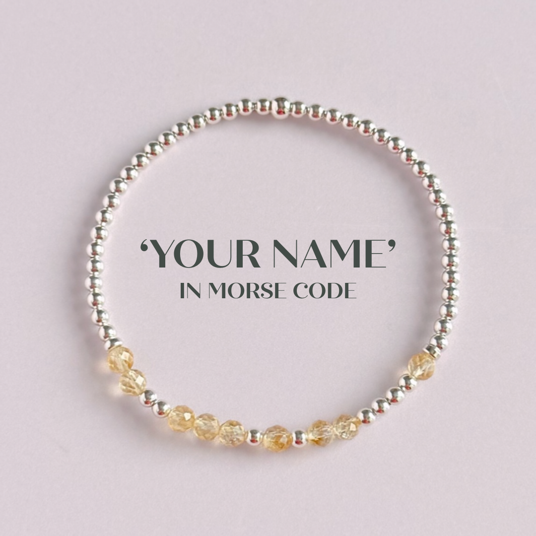 Morse code secret message bracelet spelling out your chosen name in sterling silver and citrine crystal beads. Elasticated with 4mm faceted citrine beads and 3mm sterling silver beads. Custom November birthstone bracelet.