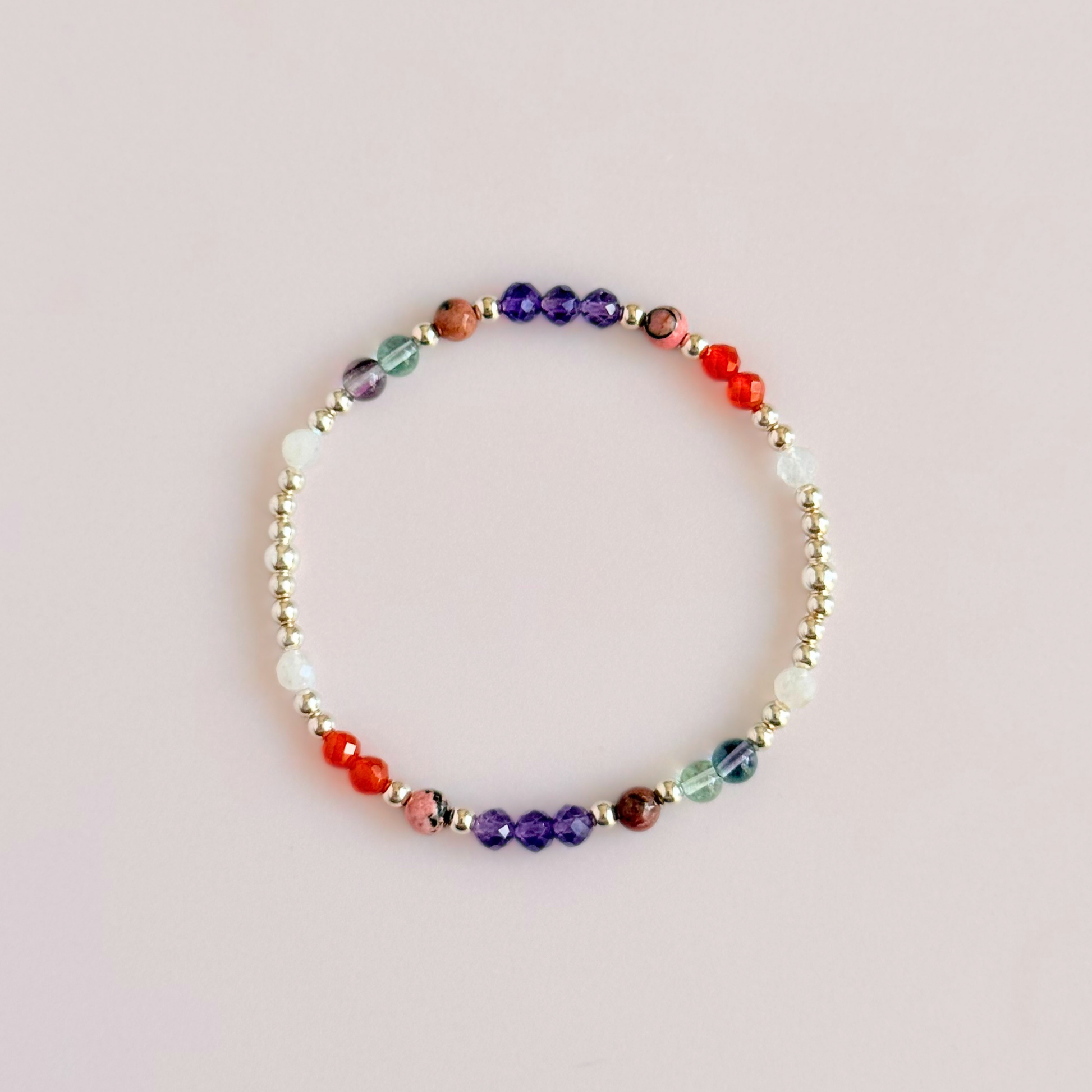 Dainty sterling silver crystal bracelet featuring five crystals, in 4mm faceted and smooth round style, each believed to help with perimenopause symptoms. Featuring amethyst, rhodonite, fluorite, moonstone and carnelian. Pictured from above.
