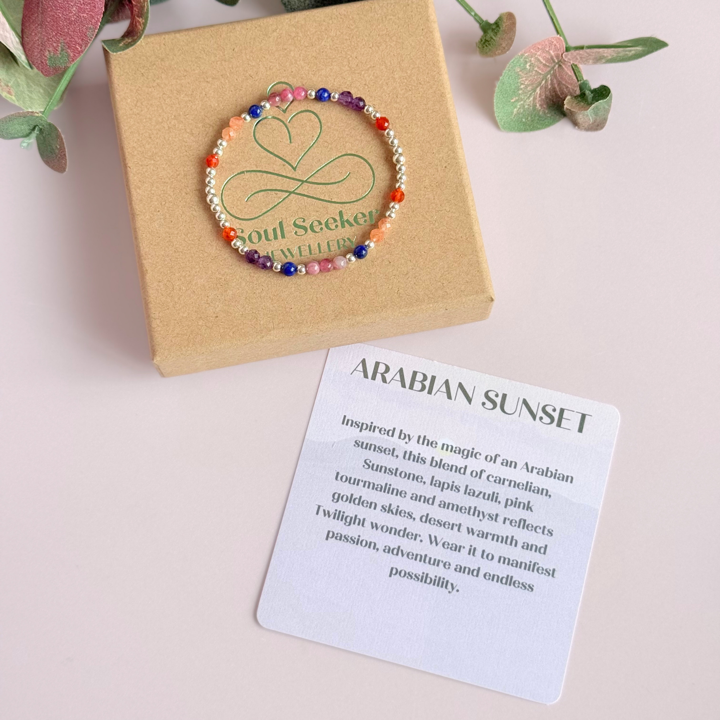 ‘Arabian Sunset' sterling silver dainty beaded bracelet with pink tourmaline, sunstone, carnelian, lapis lazuli and amethyst. Made with round 3mm sterling silver beads and 4mm smooth and faceted round crystal gemstone beads. Pictured on the gift box, with the crystal information card