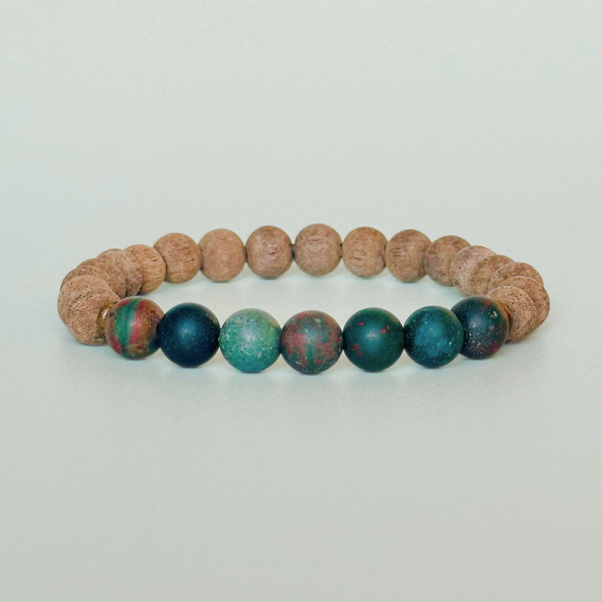 Men’s crystal bracelet featuring 8mm matte bloodstone beads, 8mm raw greywood beads with sandalwood spacer beads.