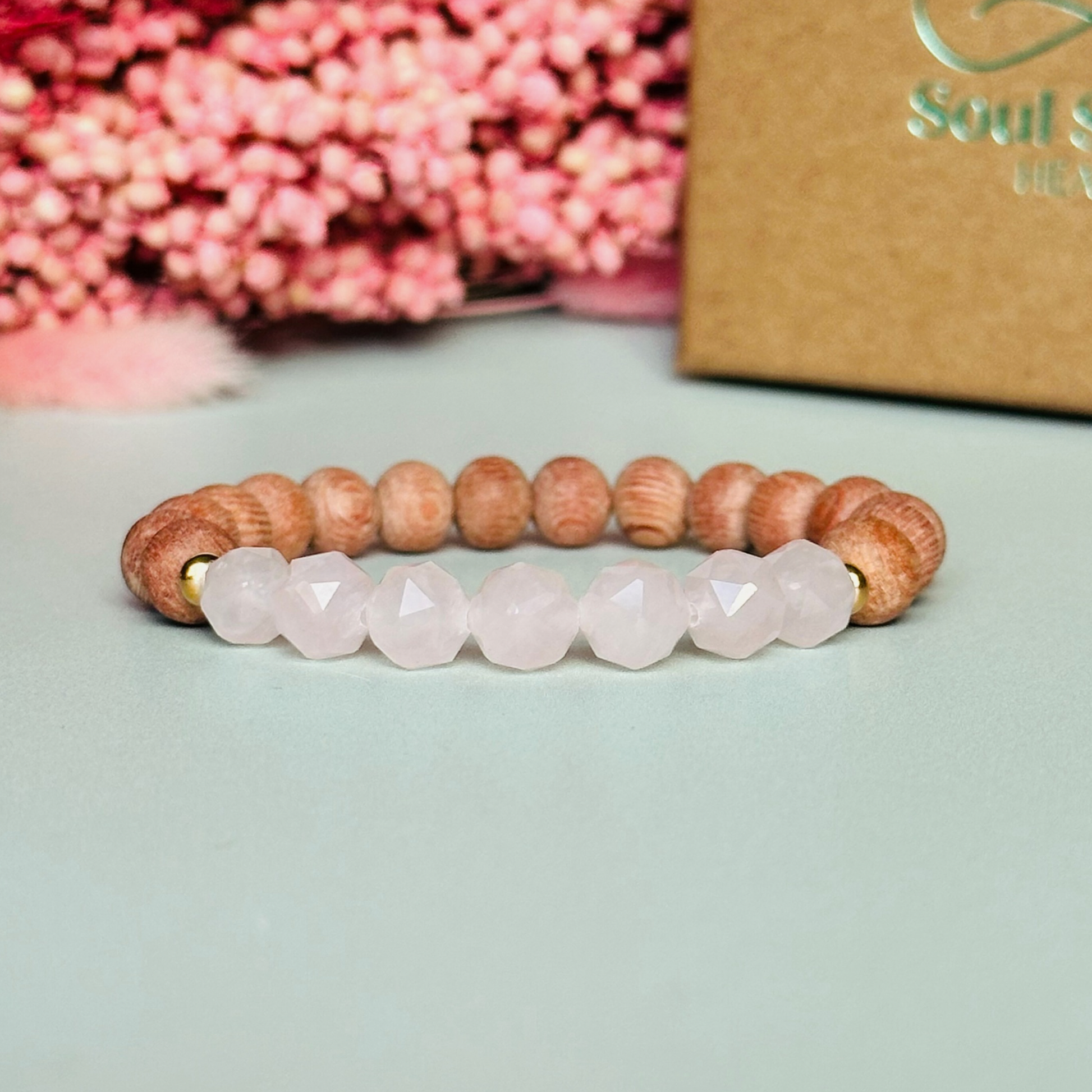 Rose quartz and raw rosewood elasticated essential oil diffuser bracelet. Made with 8mm star cut rose quartz beads, 8mm round raw rosewood beads and your choice of sterling silver, gold vermeil or rose gold vermeil spacer beads
