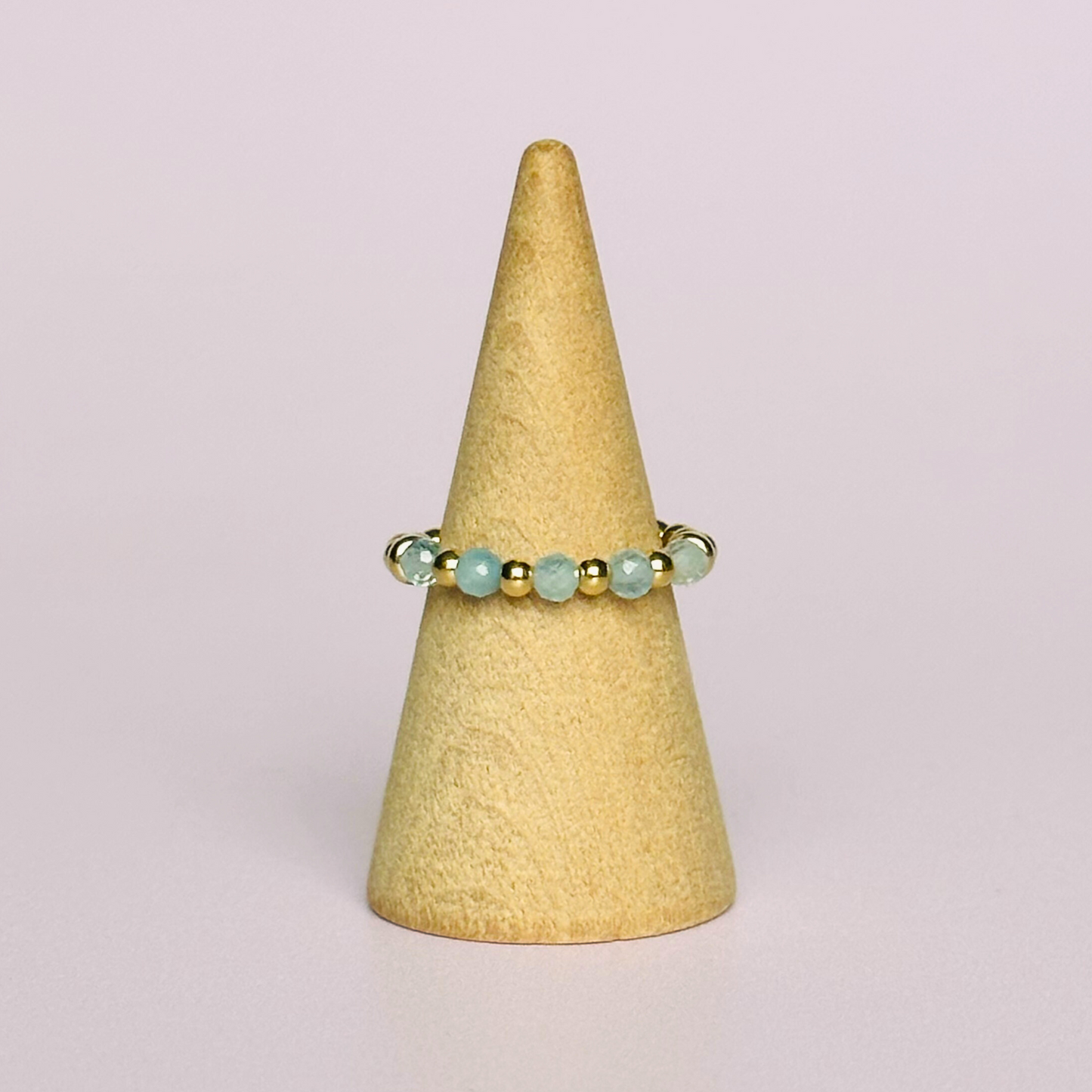 Gold vermeil aquamarine ring featuring five 3mm faceted round aquamarine beads on a elasticated ring band of 2.5mm gold vermeil beads. March birthstone ring.