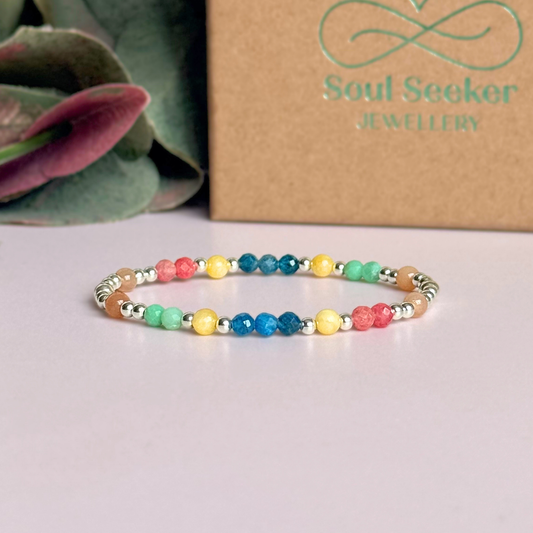 'Key West' sterling silver dainty beaded bracelet with apatite, rhodochrosite, yellow calcite, chrysoprase and peach moonstone. Made with round 3mm sterling silver beads and 4mm smooth and faceted round crystal gemstone beads. Pictured in front of the gift box