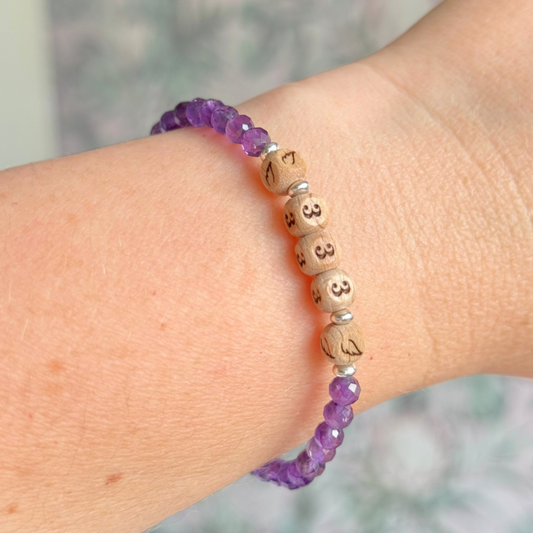Bracelet featuring engraved wooden 333 angel number and wing beads, on the band of 4mm faceted amethyst round crystal gemstone beads. Finished with your choice of gold vermeil, sterling silver or rose gold vermeil accent beads.