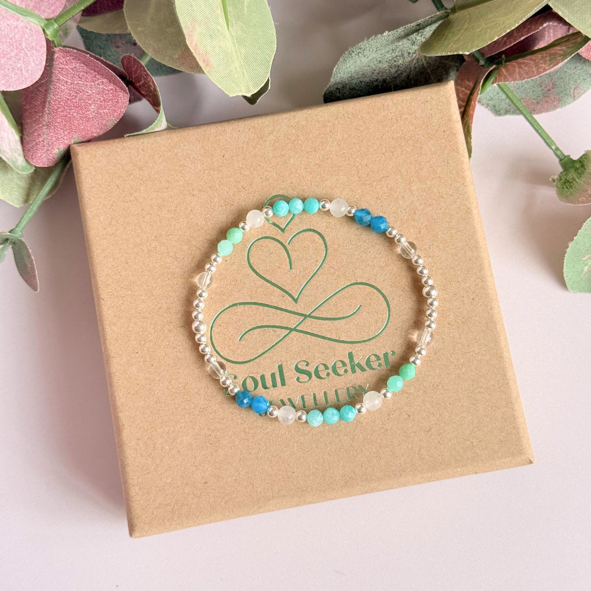 ‘Caribbean Dream' sterling silver dainty beaded bracelet with white jade, chrysoprase, amazonite, apatite and clear quartz. Made with round 3mm sterling silver beads and 4mm smooth and faceted round crystal gemstone beads. Pictured on the gift box, from above 