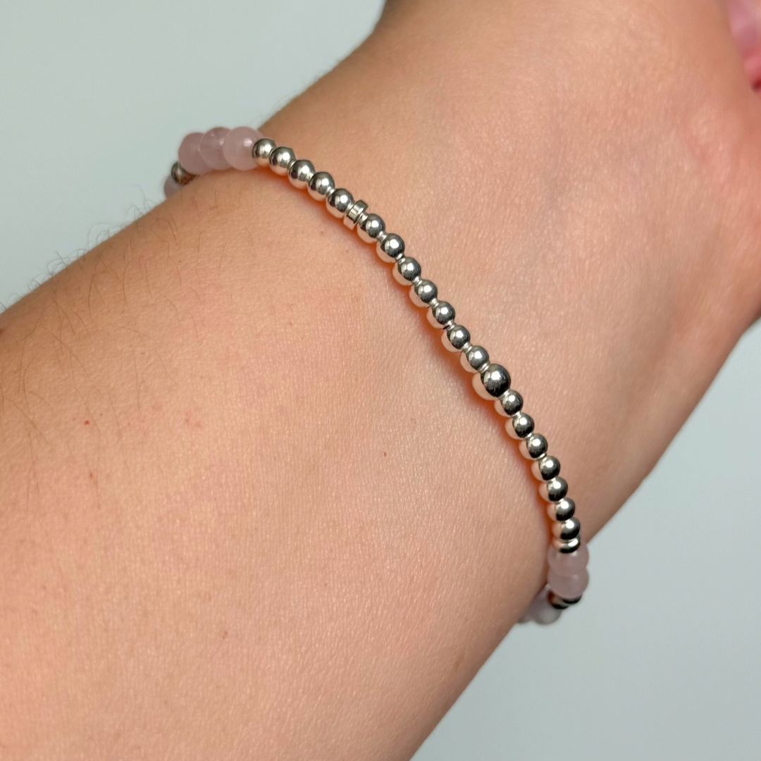 Morse code secret message bracelet spelling out the words Mum est. 2025 in sterling silver and rose quartz crystal beads. elasticated with 4mm rose quartz beads and 3mm sterling silver beads.