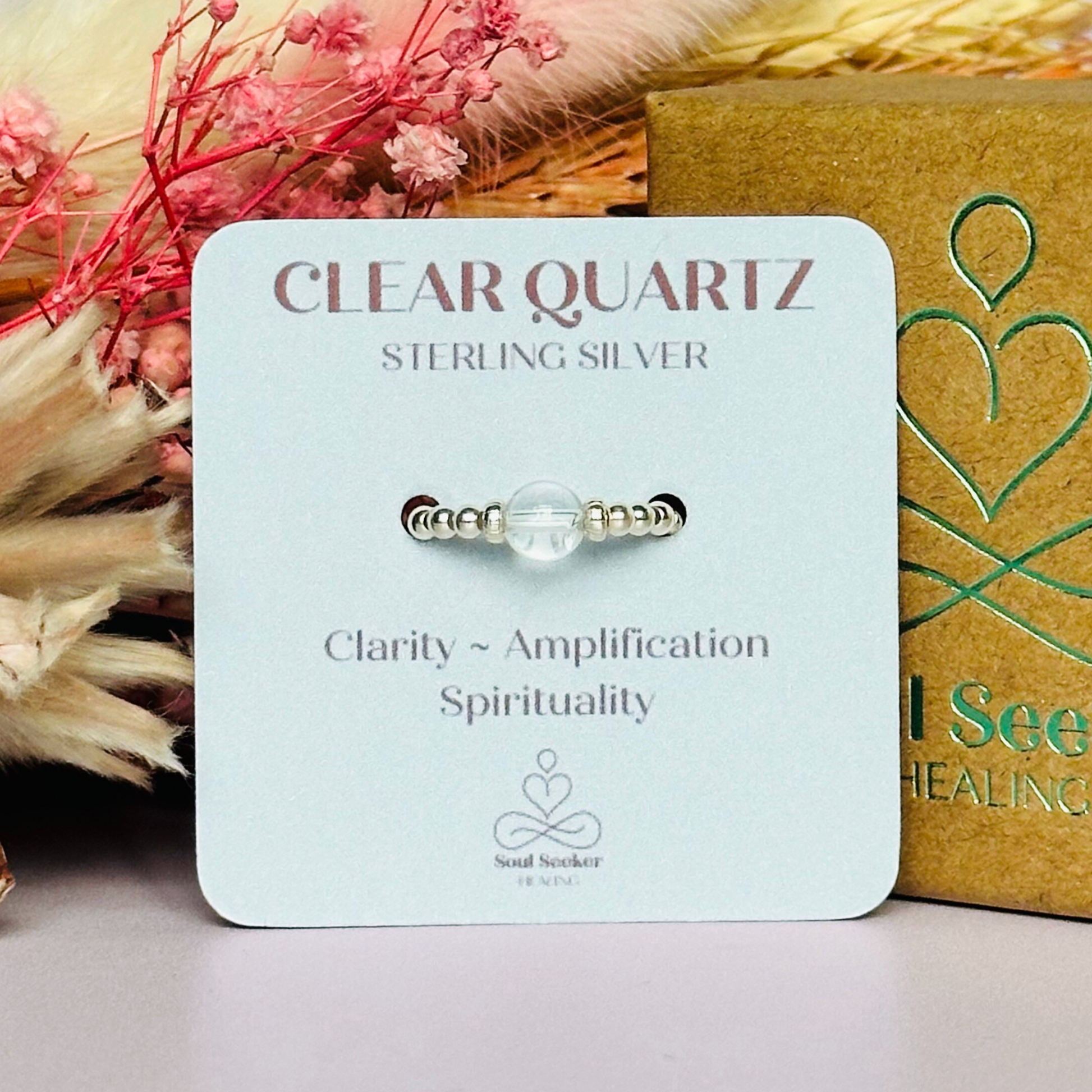 This sterling silver clear quartz ring features a 6mm round ethically sourced clear quartz bead, surrounded by sterling silver corrugated rondelle beads and delicate 2.5mm sterling silver beads. April birthstone.
