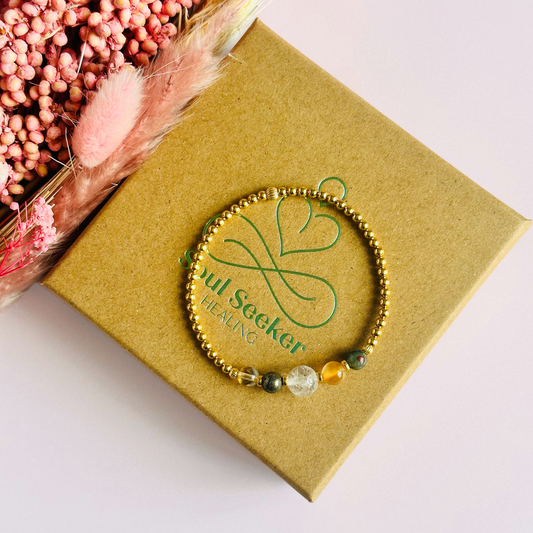 This gold vermeil Aries bracelet is made with a selection of five healing crystals all believed to resonate with the Aries zodiac sign. The central bead is 8mm, the other four are 6mm. On an elasticated band of 3mm gold vermeil beads with corrugated accent beads. Featuring citrine, bloodstone, carnelian, pyrite and clear quartz.