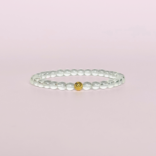 Clear quartz bracelet featuring 6mm round clear quartz beads with either a sterling silver or gold vermeil faceted focal bead￼