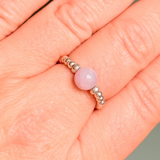 Crystal ring with a 6mm kunzite round bead on an elasticated ring band of 2.5mm sterling silver ball beads.