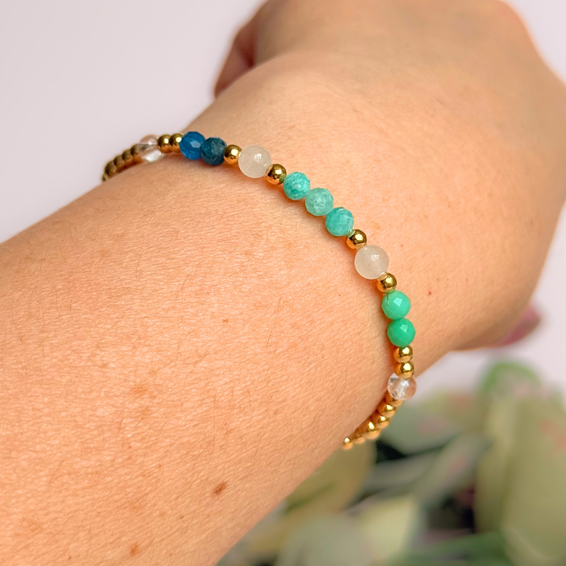 ‘Caribbean Dream' gold vermeil dainty beaded bracelet with white jade, chrysoprase, amazonite, apatite and clear quartz. Made with round 3mm gold vermeil beads and 4mm smooth and faceted round crystal gemstone beads. Pictured being worn, at an angle