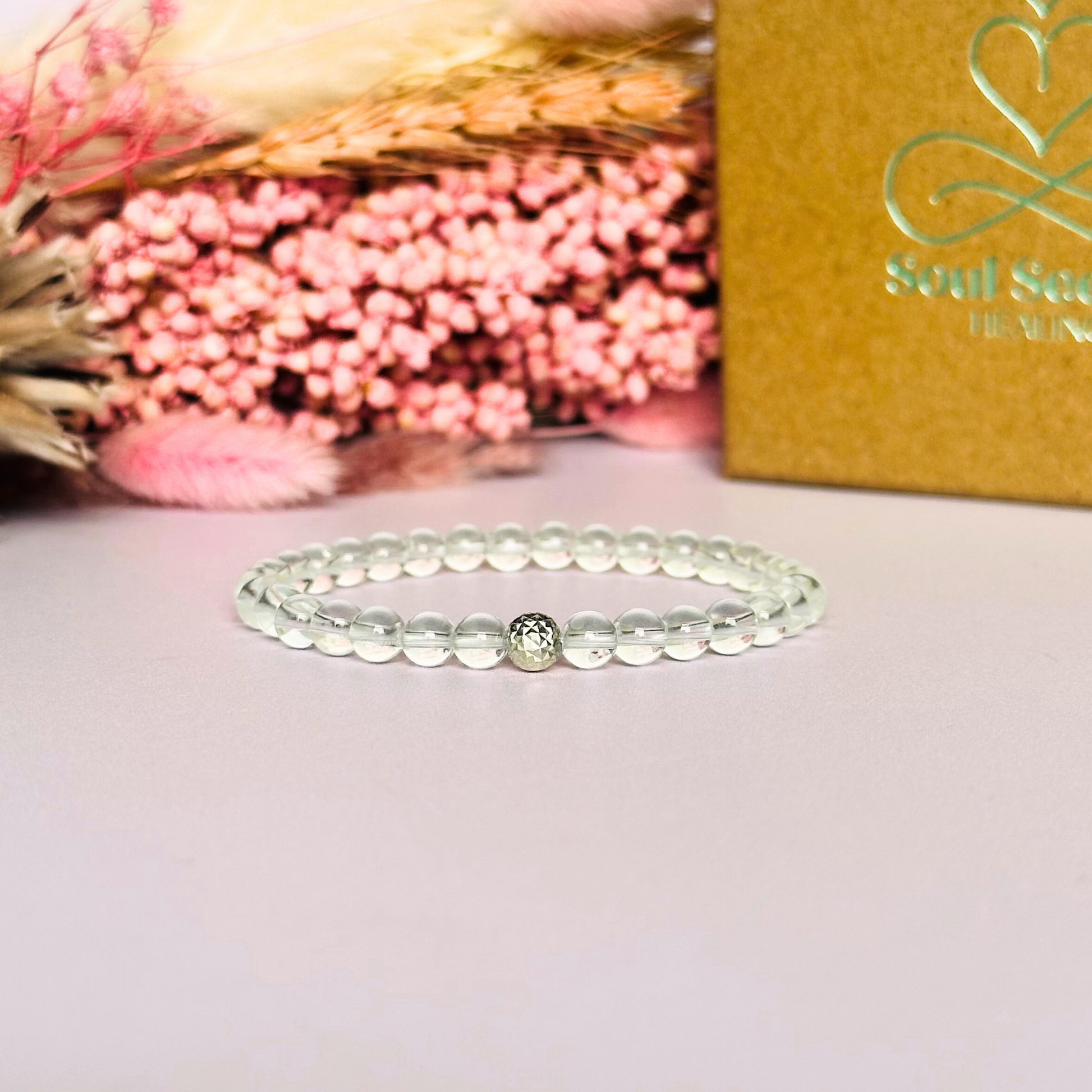 Clear quartz bracelet featuring 6mm round clear quartz beads with either a sterling silver or gold vermeil faceted focal bead