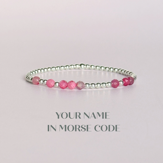 Morse code secret message bracelet spelling out your chosen name in sterling silver and pink tourmaline crystal beads. Elasticated with 4mm faceted pink tourmaline beads and 3mm sterling silver beads. Custom October birthstone bracelet.