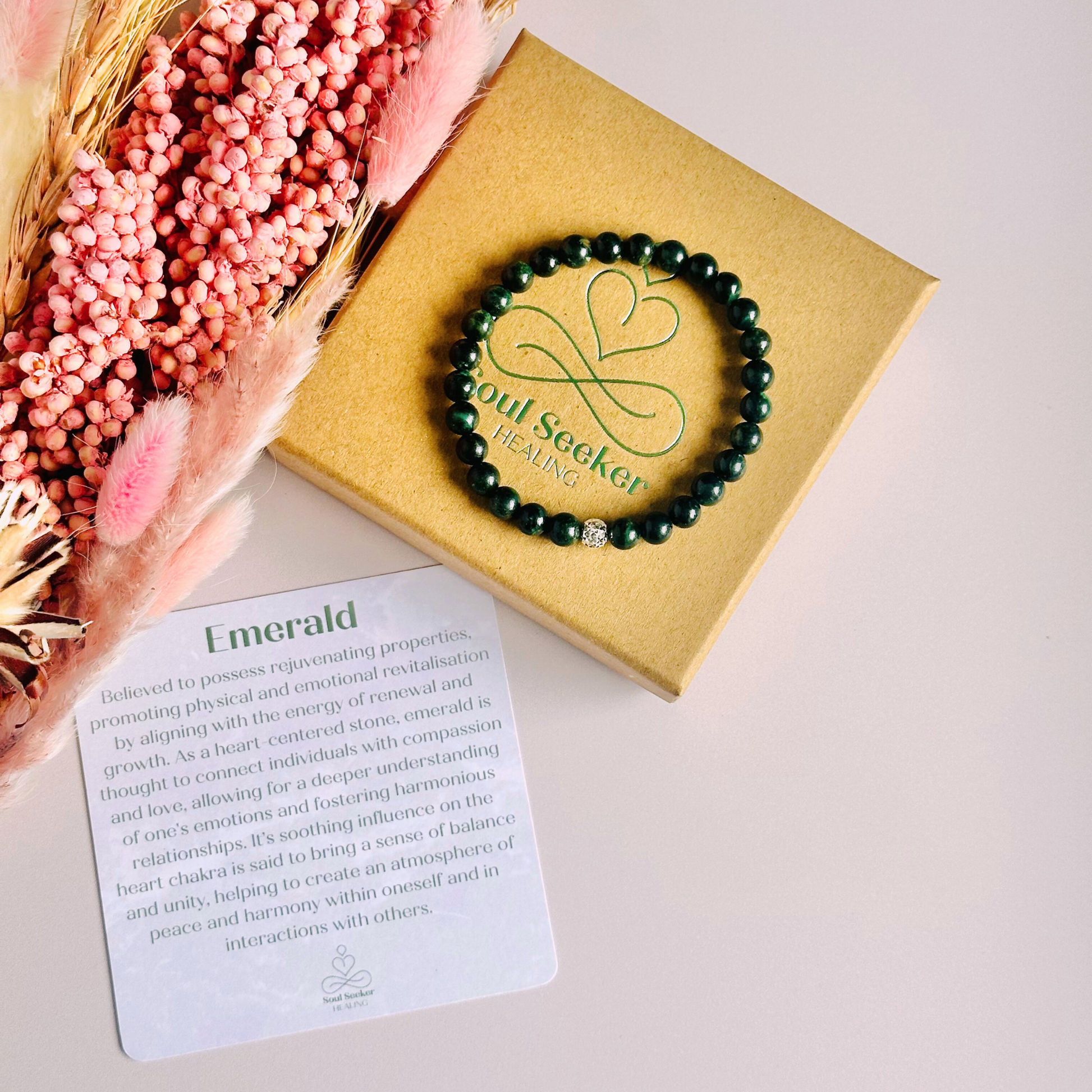 Crystal healing bracelet featuring a band of 6mm, dark Emerald genuine round beads with one 6mm faceted bead as a focal point, in either sterling silver or gold vermeil. Elasticated for comfort