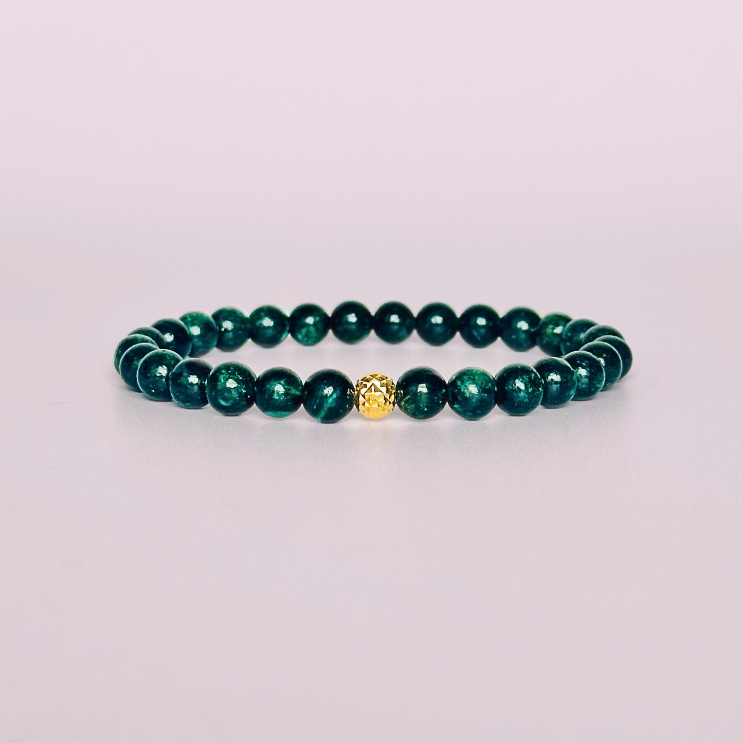 Crystal healing bracelet featuring a band of 6mm, dark Emerald genuine round beads with one 6mm faceted bead as a focal point, in either sterling silver or gold vermeil. Elasticated for comfort