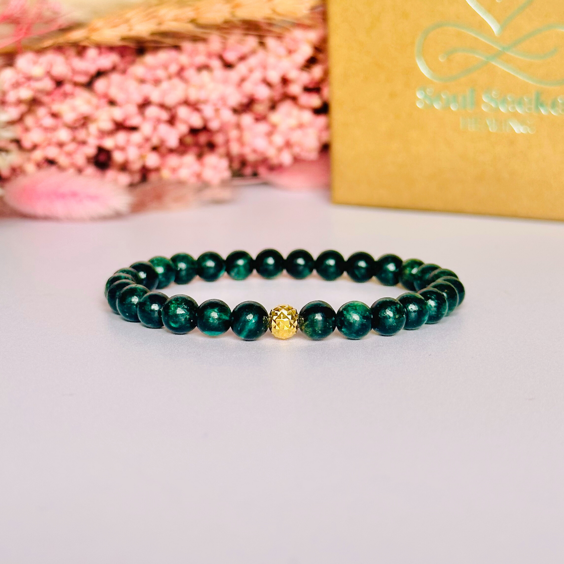 Crystal healing bracelet featuring a band of 6mm, dark Emerald genuine round beads with one 6mm faceted bead as a focal point, in either sterling silver or gold vermeil. Elasticated for comfort