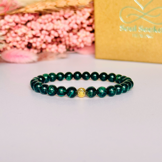Crystal healing bracelet featuring a band of 6mm, dark Emerald genuine round beads with one 6mm faceted bead as a focal point, in either sterling silver or gold vermeil. Elasticated for comfort