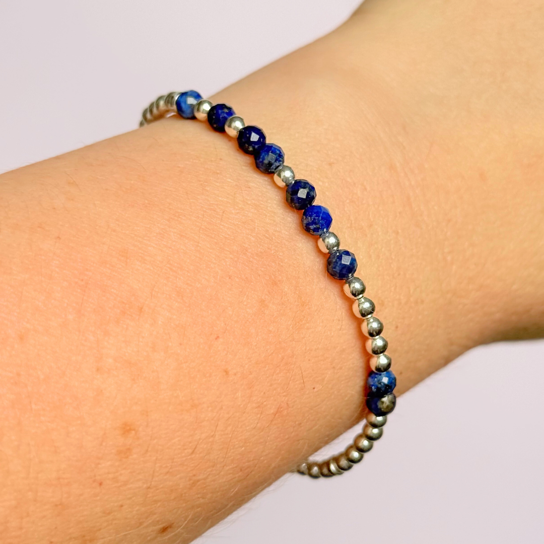 Morse code secret message bracelet spelling out your chosen name in sterling silver and lapis lazuli crystal beads. Elasticated with 4mm faceted lapis lazuli beads and 3mm sterling silver beads. Custom September birthstone bracelet.