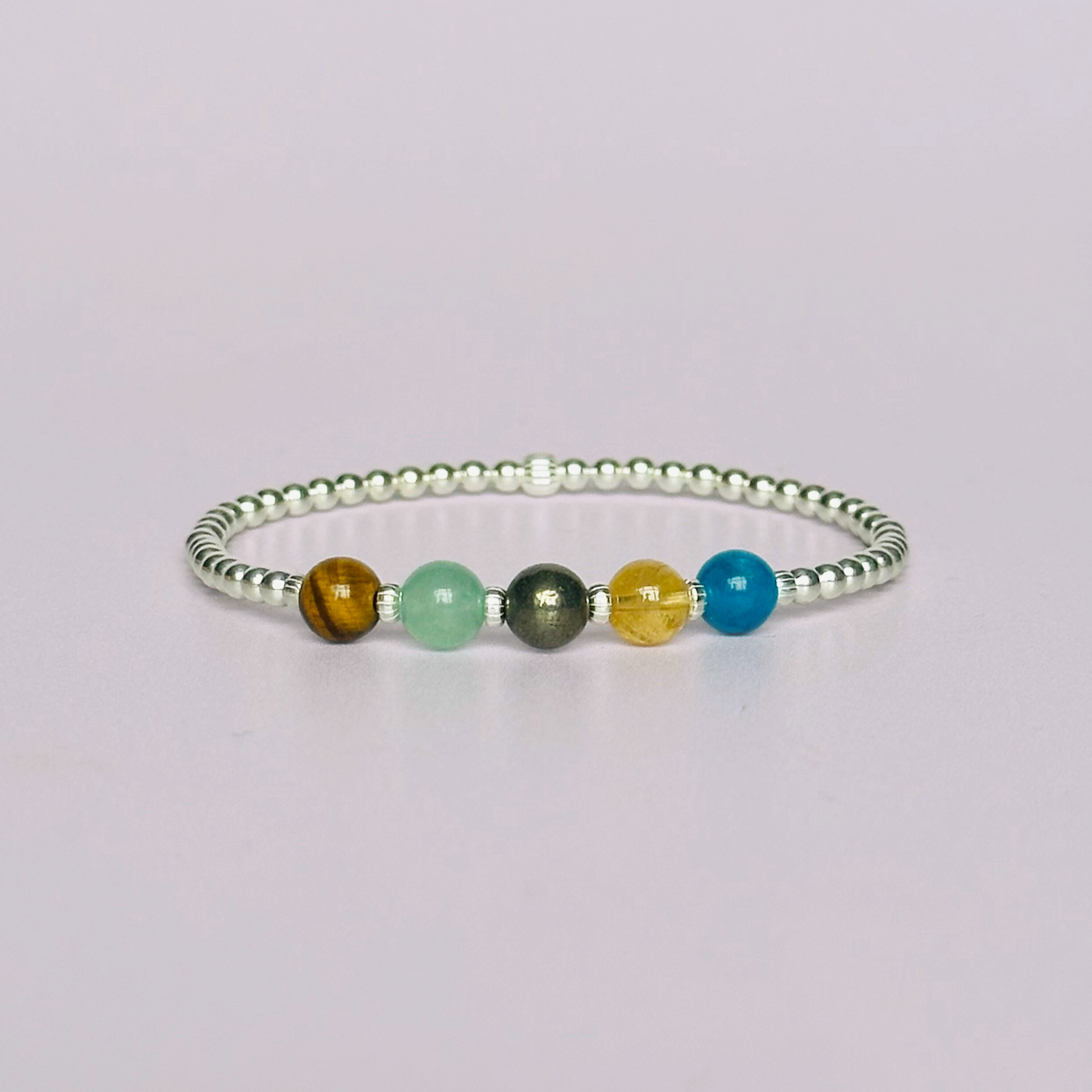 This sterling silver manifesting bracelet is made with a selection of five healing crystals all believed to help achieve your dream life. The crystal beads are all 6mm and are on a band of 3mm sterling silver beads with corrugated accent beads.