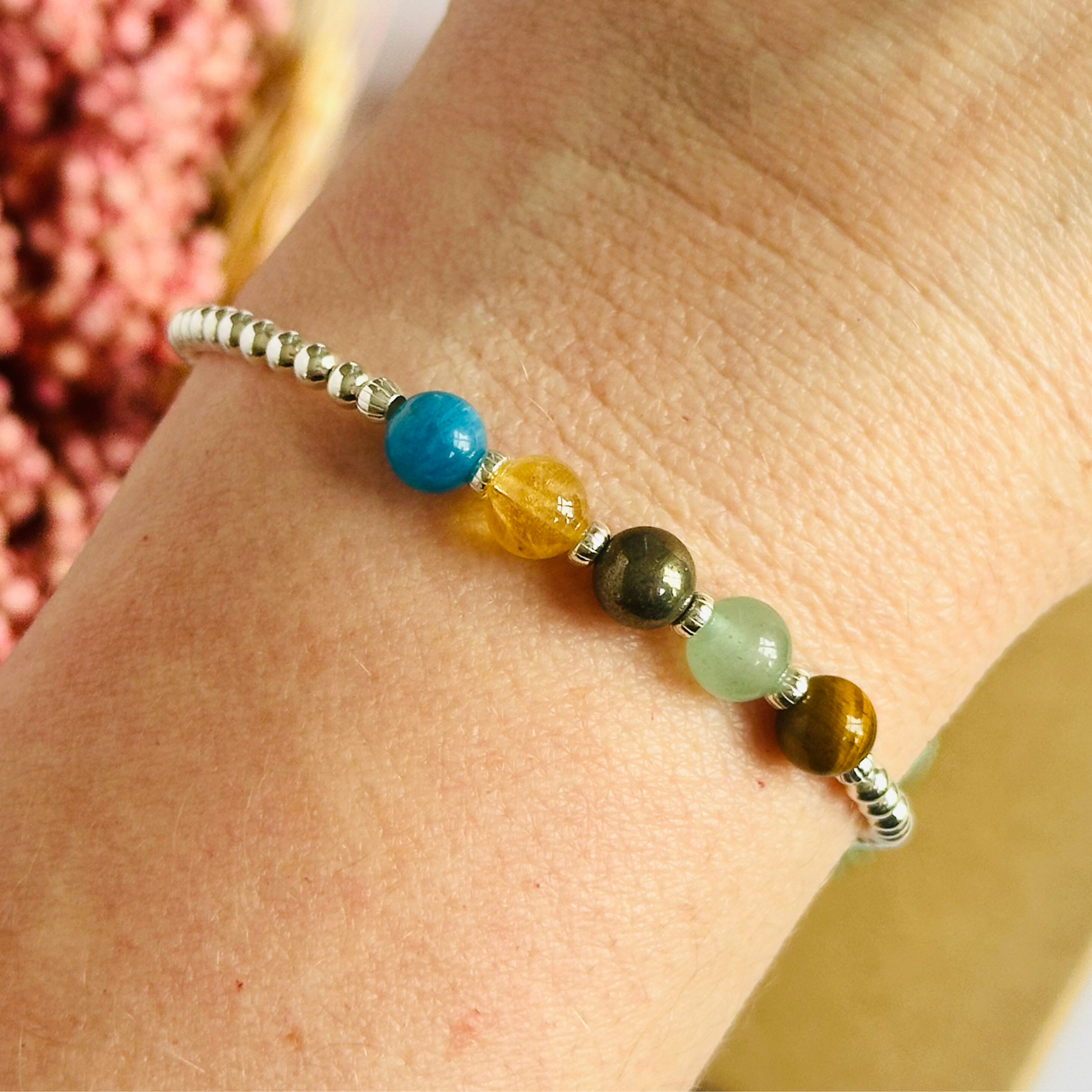 This sterling silver manifesting bracelet is made with a selection of five healing crystals all believed to help achieve your dream life. The crystal beads are all 6mm and are on a band of 3mm sterling silver beads with corrugated accent beads.