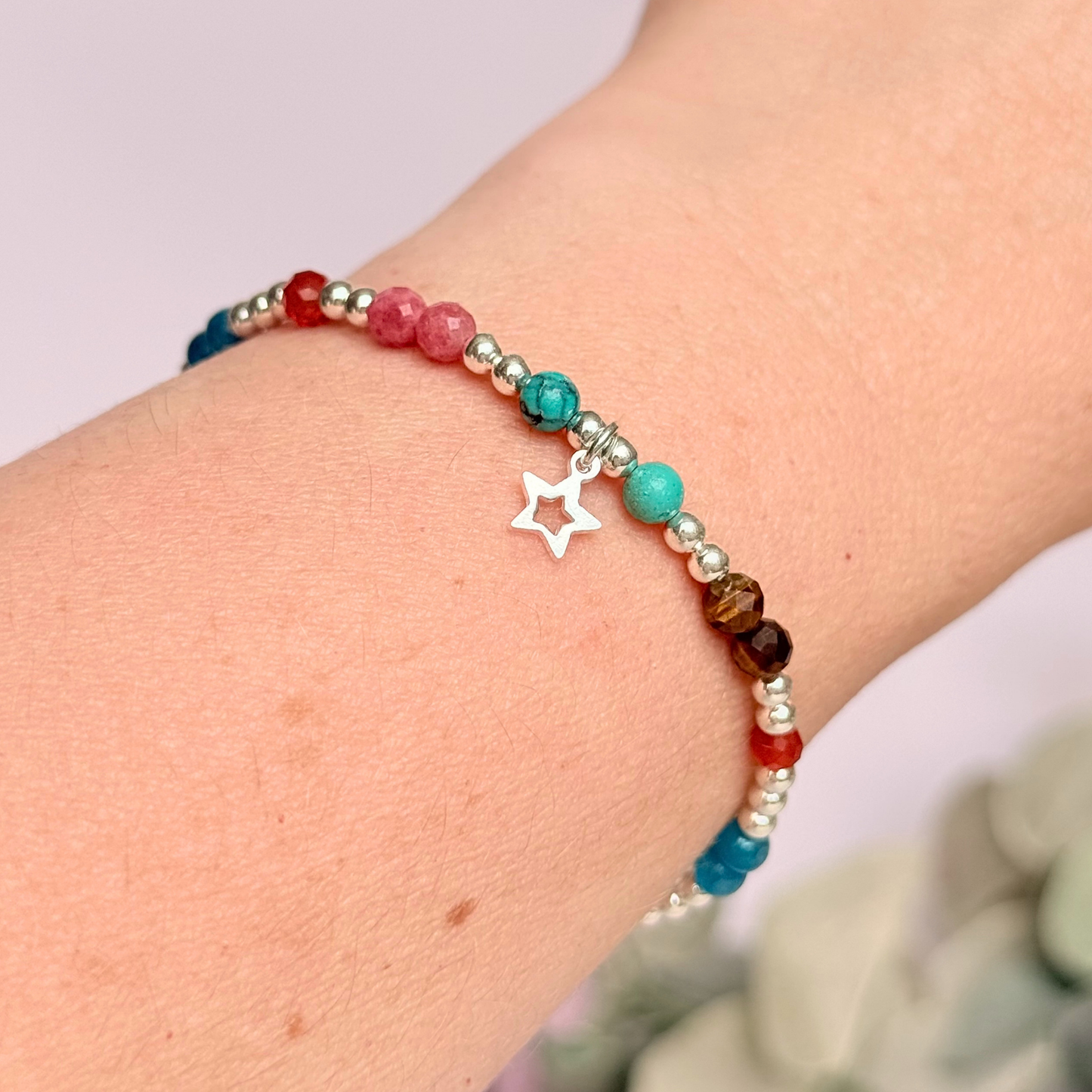 'Hot girl summer' sterling silver dainty beaded bracelet with tigers eye, turquoise, apatite, carnelian and rhodochrosite. With a beautiful open star charm. Made with round 3mm sterling silver beads and 4mm smooth and faceted round crystal gemstone beads. Pictured being worn.