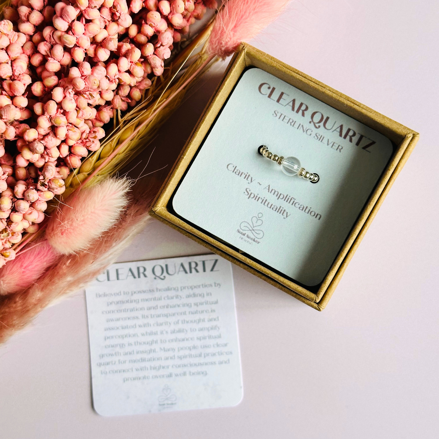 This sterling silver clear quartz ring features a 6mm round ethically sourced clear quartz bead, surrounded by sterling silver corrugated rondelle beads and delicate 2.5mm sterling silver beads. April birthstone.
